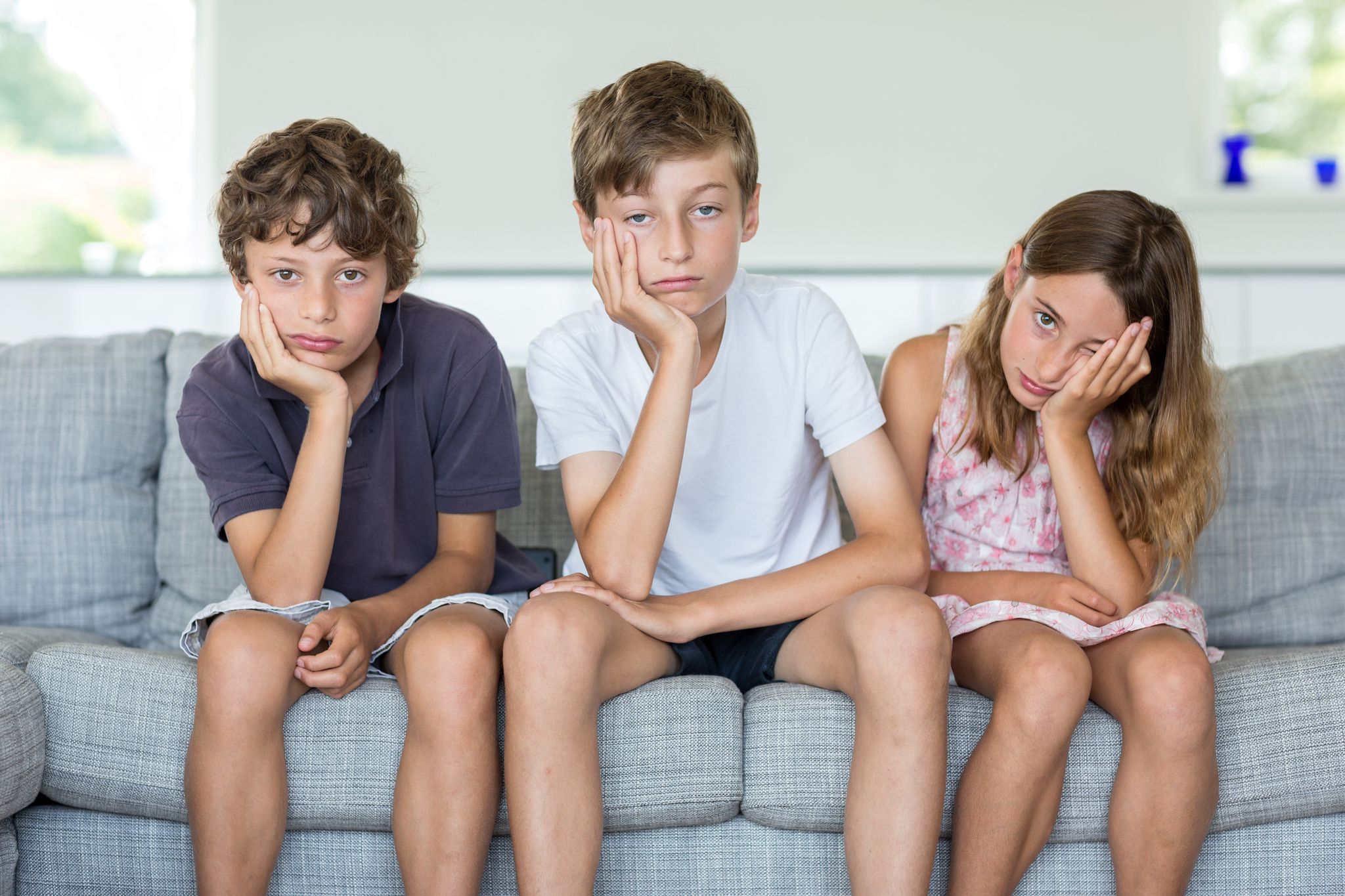 Three children looking bored. | Source: Getty Images