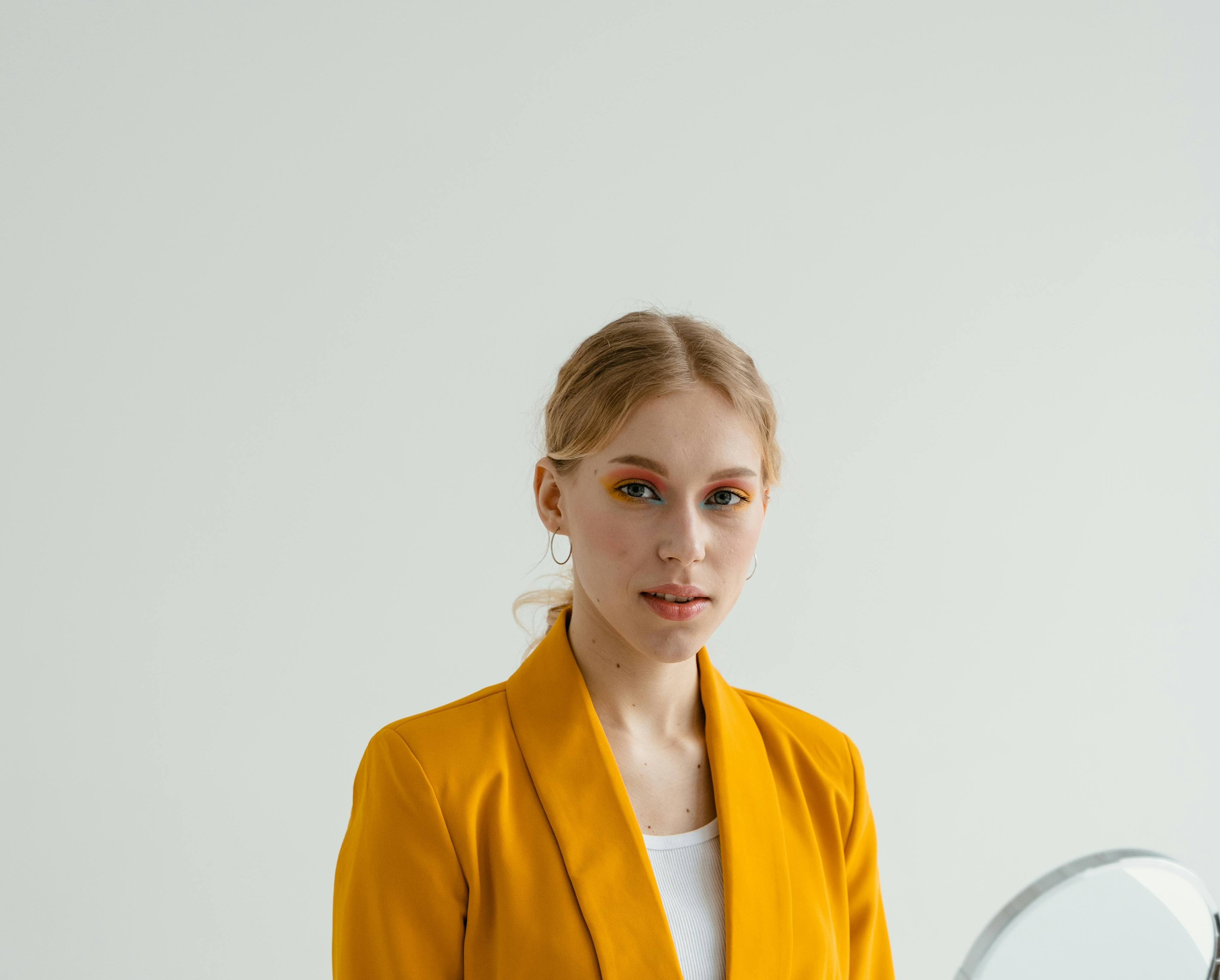 Woman in bright yellow suit smiling | Source: Pexels