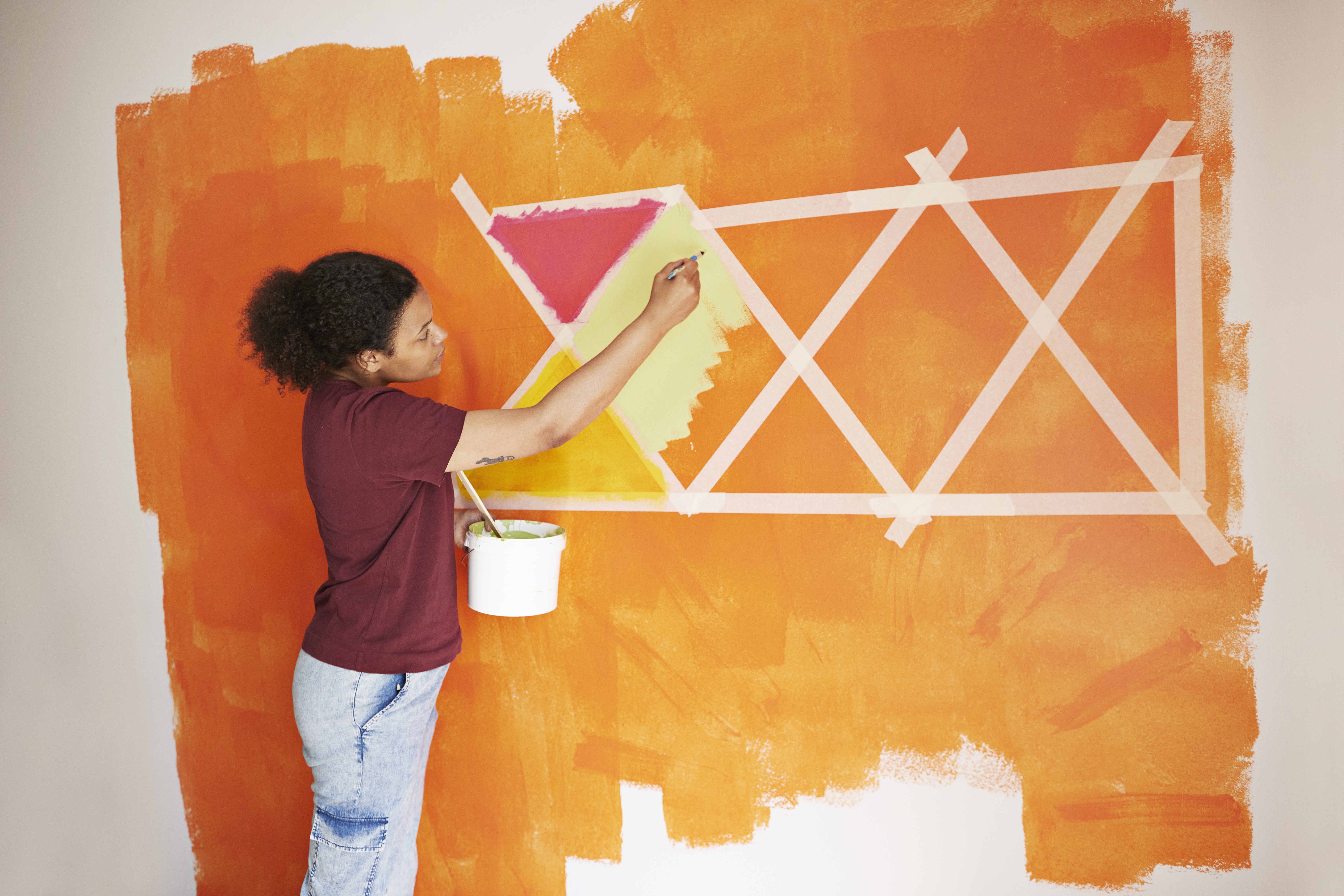 A woman painting her room | Source: Getty Images