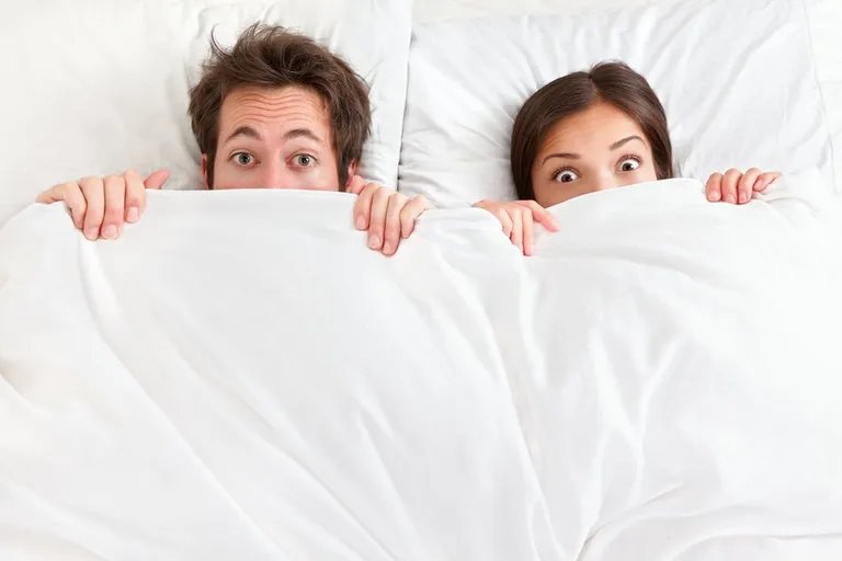 A couple in bed together | Source: Shutterstock