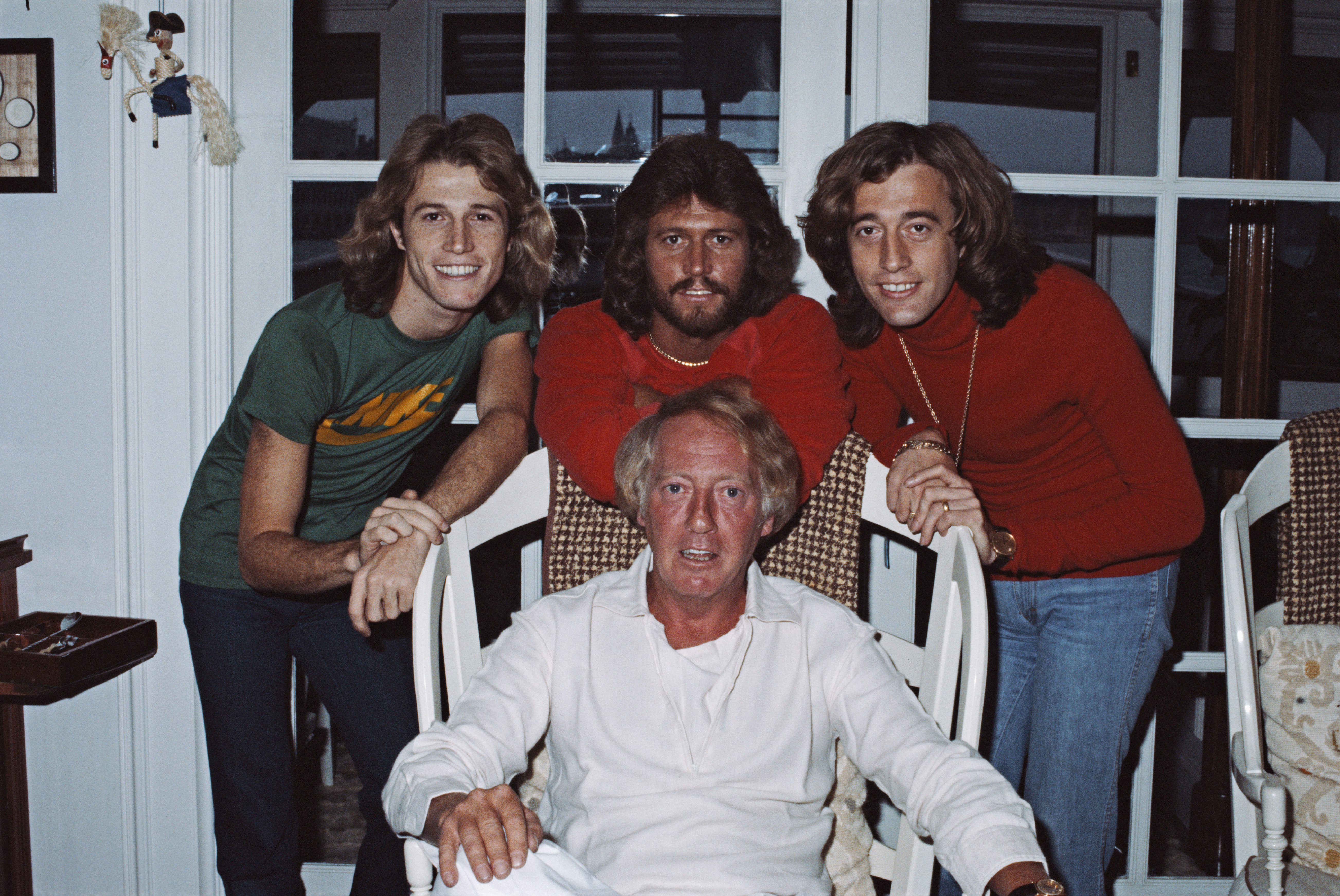 Andy Gibb, Barry Gibb, and Robin Gibb with Australian music entrepreneur Robert Stigwood in February 1979 | Source: Getty Images