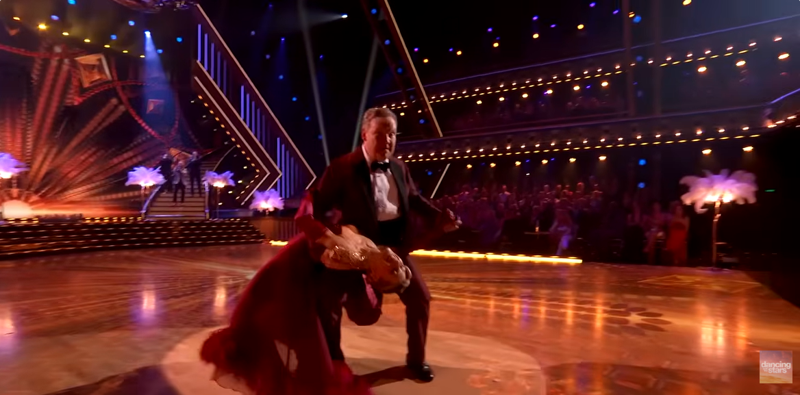 Andy Richter and Emma Slater perform on the dance floor, as seen from a video post dated November 12, 2025. | Source: YouTube/ DancingWithTheStars