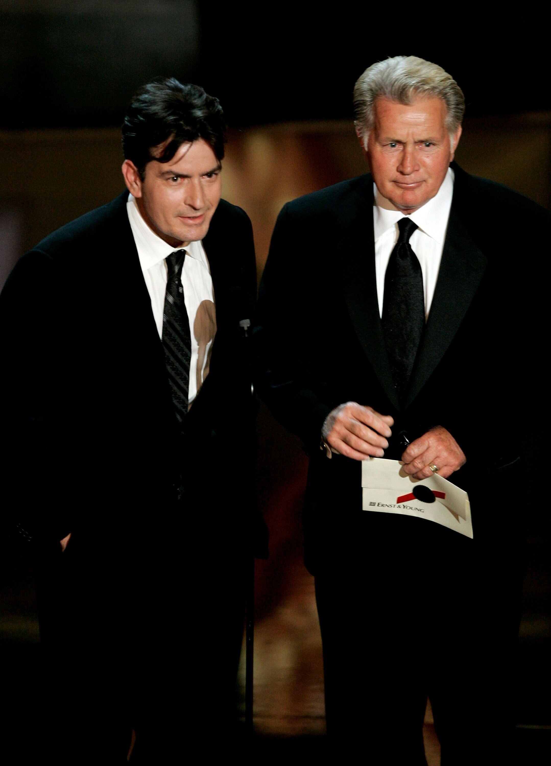 Charlie Sheen and Martin Sheen present the award for Outstanding Supporting Actress in a Drama Series onstage at the 58th Annual Primetime Emmy Awards. | Source: Getty Images