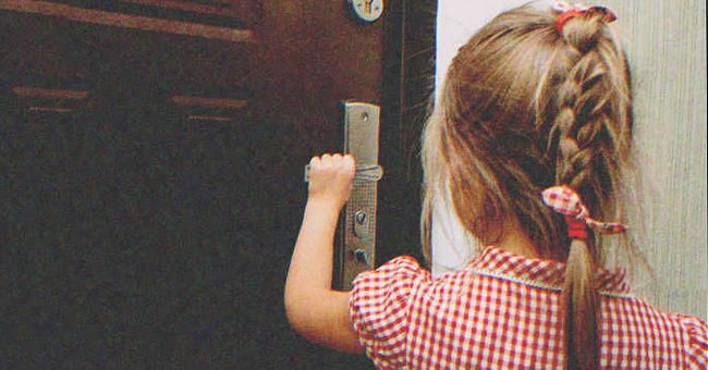 A little girl opening a door | Source: Shutterstock