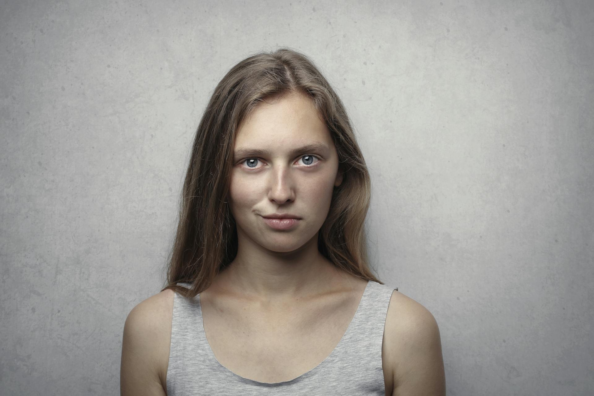 A woman smirking | Source: Pexels