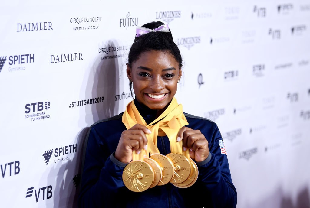 Simone Biles of The United States poses for photos with her multiple gold medals during day 10 of the 49th FIG Artistic Gymnastics World Championships at Hanns-Martin-Schleyer-Halle in Stuttgart, Germany | Photo: Getty Images