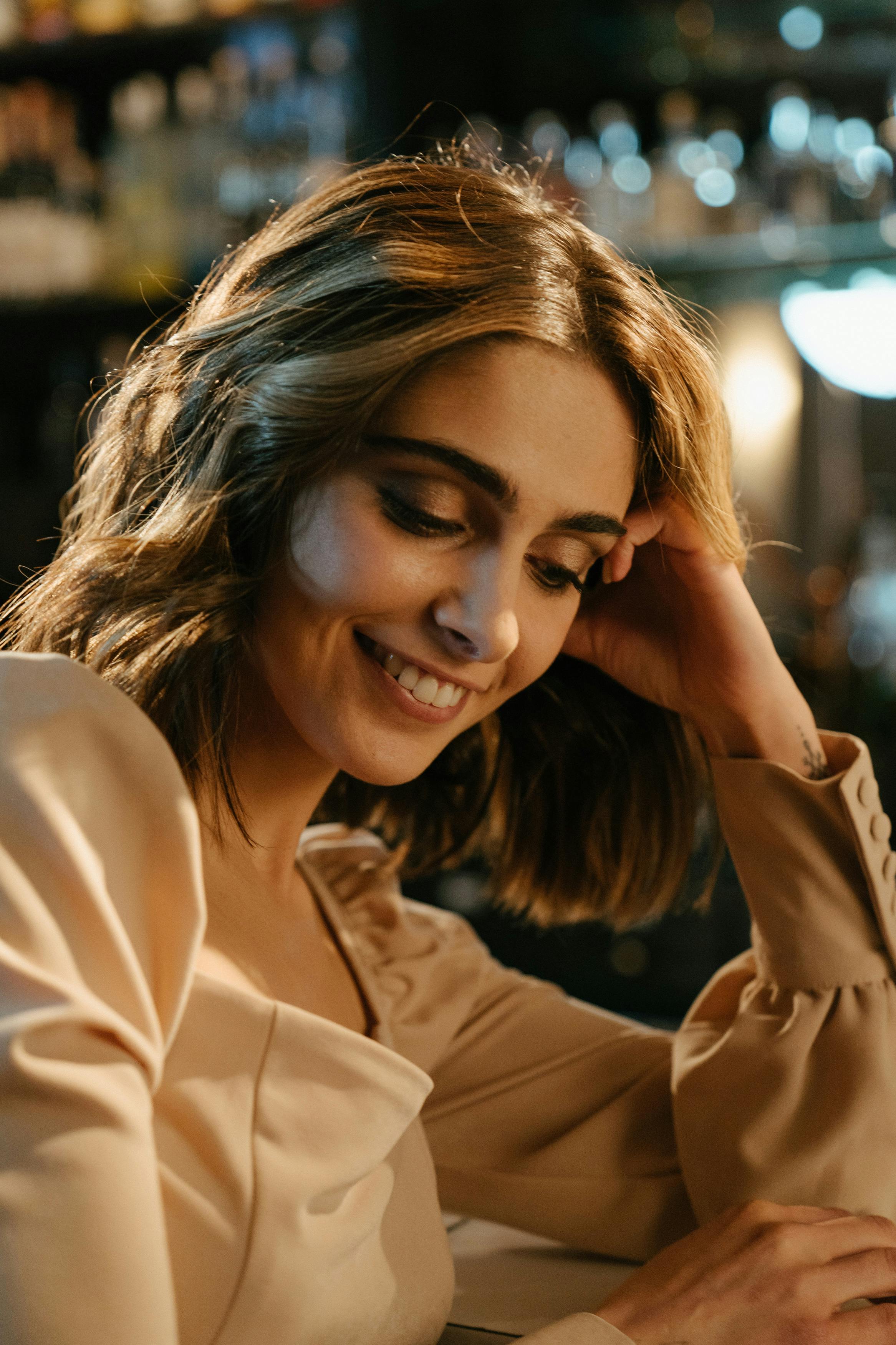 A happy woman smiling at a restaurant | Source: Pexels