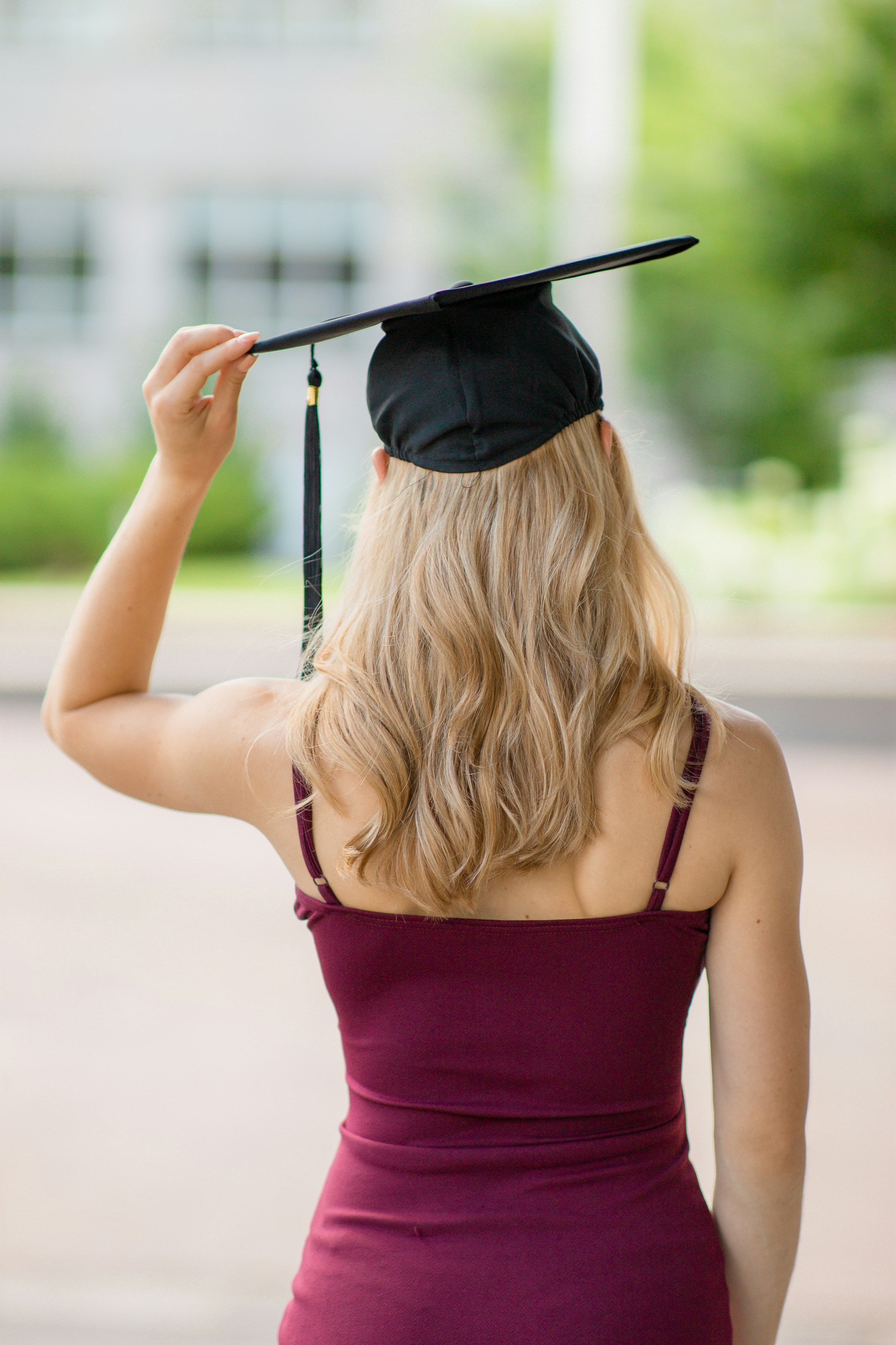 A young woman holding back mortar board during daytime | Source: Unsplash