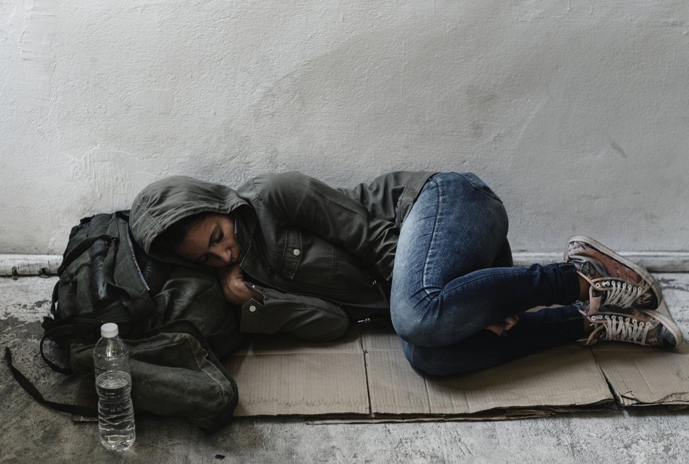 Mujer sin hogar durmiendo en el piso. | Foto: Shutterstock