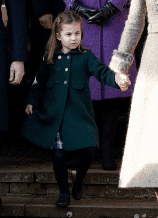 Princess Charlotte holds her mother, Kate Middleton’s hand as she dips into a curtsy for Queen Elizabeth at the Christmas Day Church service at Church of St Mary Magdalene on the Sandringham estate, on December 25, 2019 in King's Lynn, England | Source: Mark Cuthbert/UK Press via Getty Images