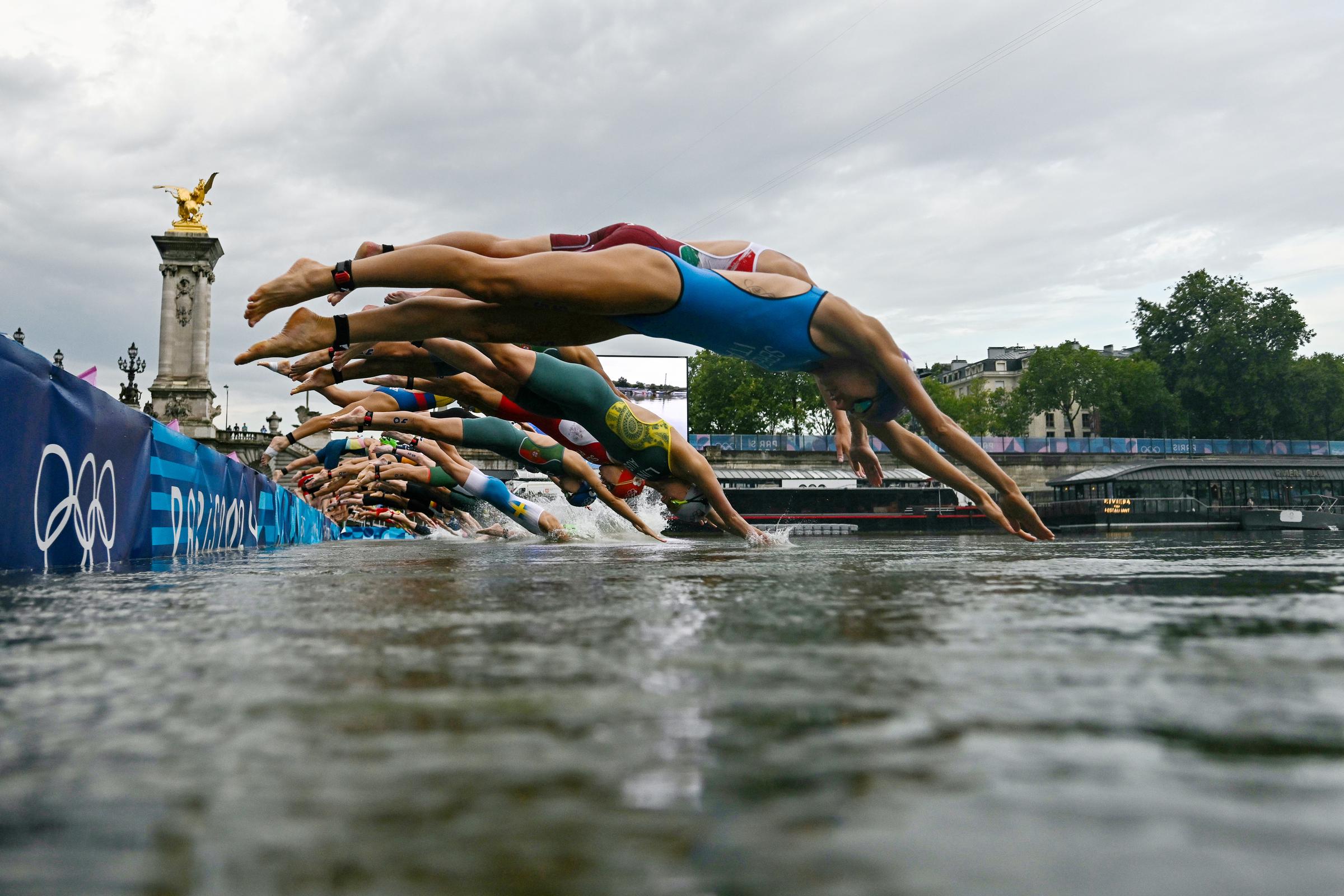 Athletes compete in the swimming race in the Seine during the Women's Individual Triathlon event at the Paris 2024 Olympic Games in Paris, France, on July 31, 2024 | Source: Getty Images