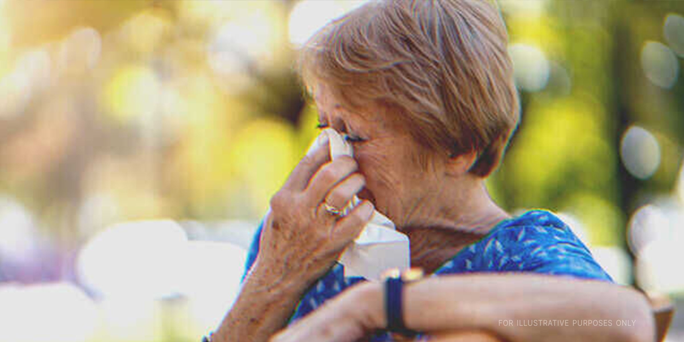 An older woman wiping her tears | Source: Shutterstock