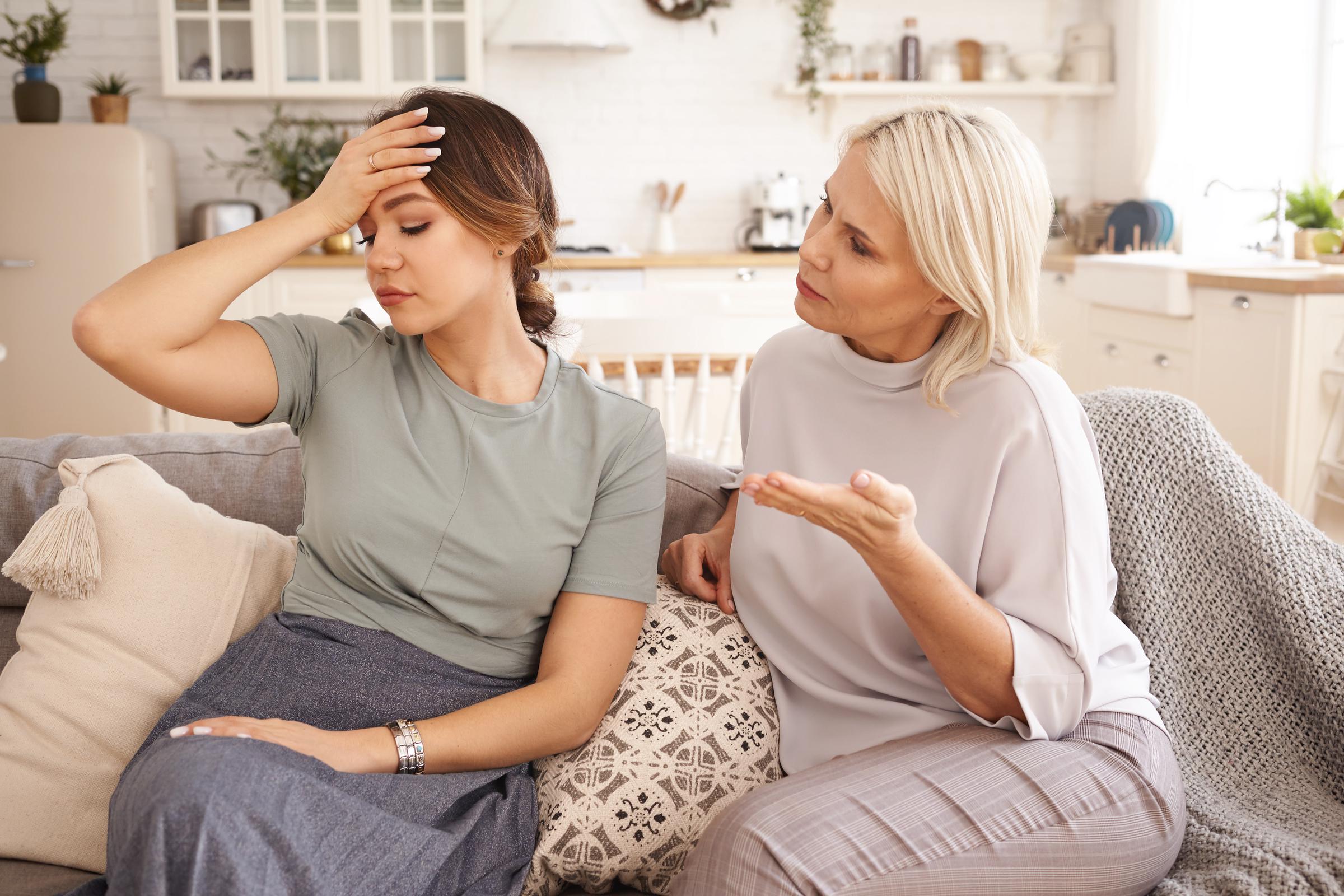 Two women sitting on a couch at home | Source: Freepik