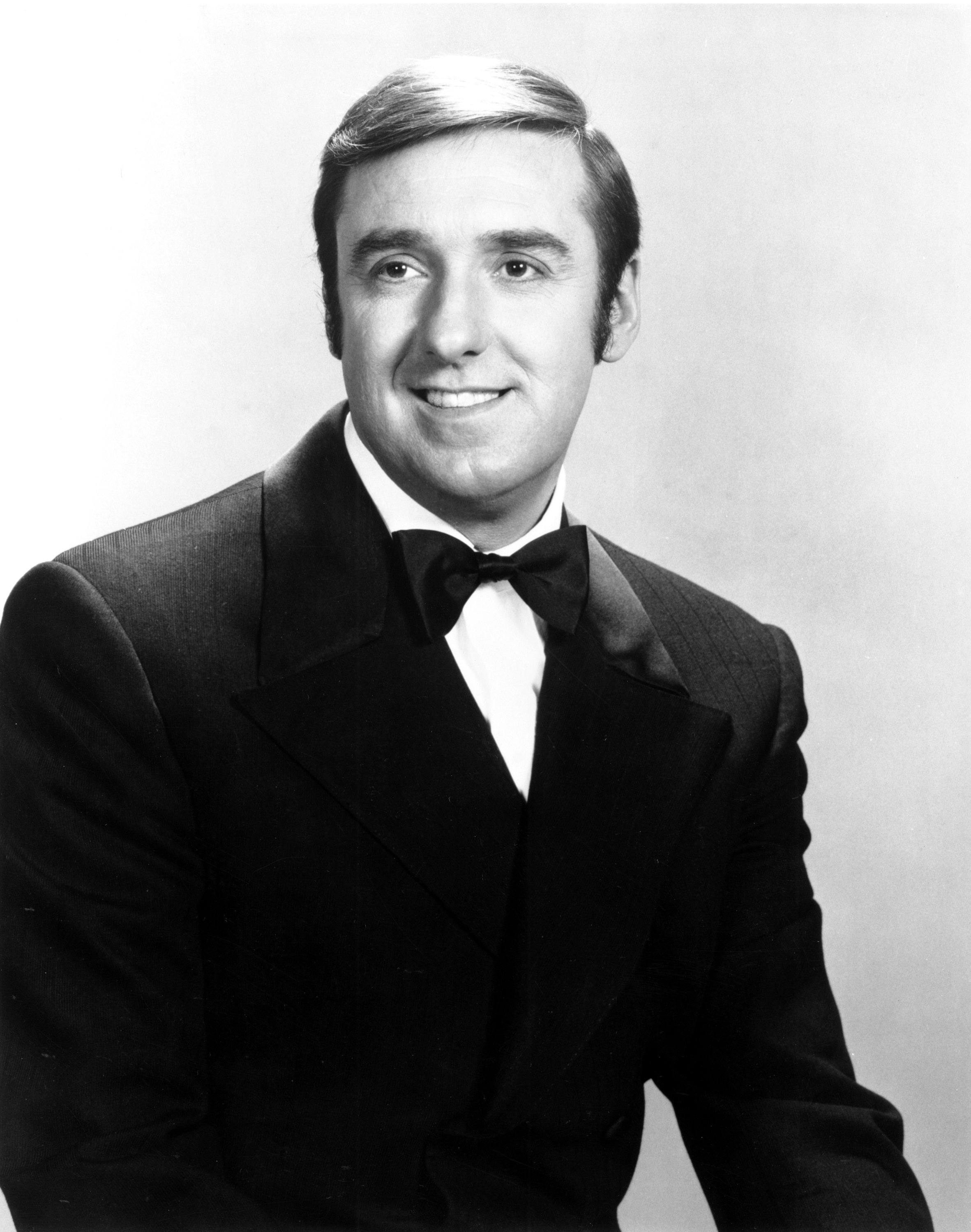 Jim Nabors pictured smiling while posing in a black tuxedo. | Source: Getty Images
