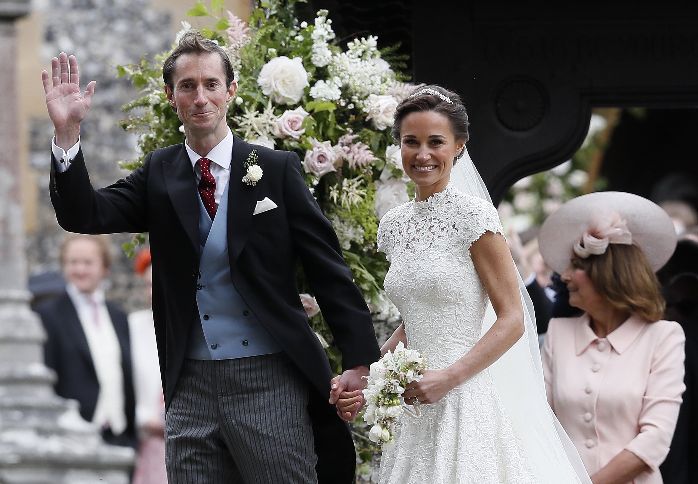Pippa Middleton and James Matthews smile for the cameras after their wedding at St Mark's Church | Source: Getty Images