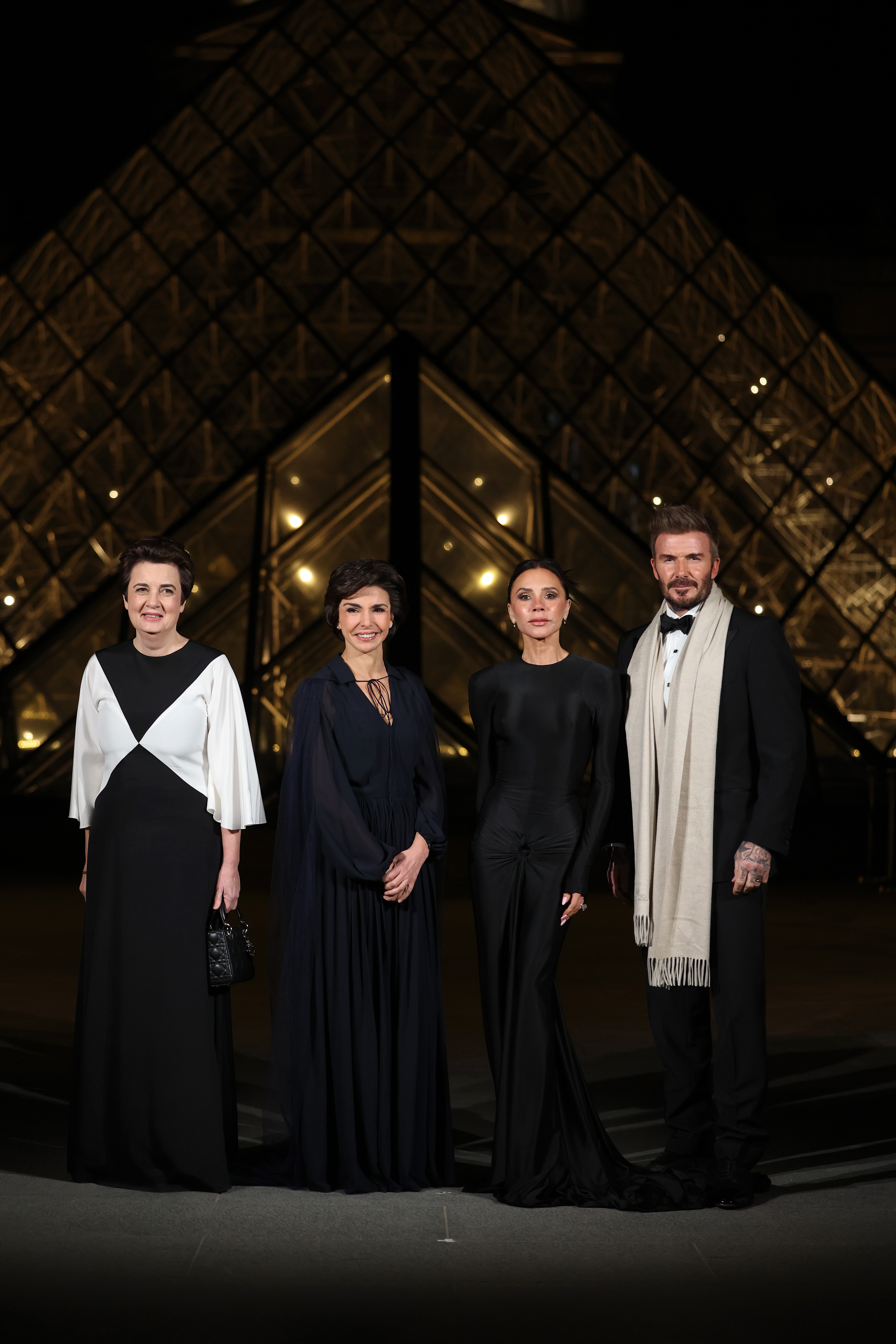 Laurence des Cars, Rachida Dati, Victoria Beckham, and David Beckham attend the "Le Grand Diner du Louvre" Passage Richelieu Photocall at Musee du Louvre in Paris, France, on March 4, 2025 | Source: Getty Images