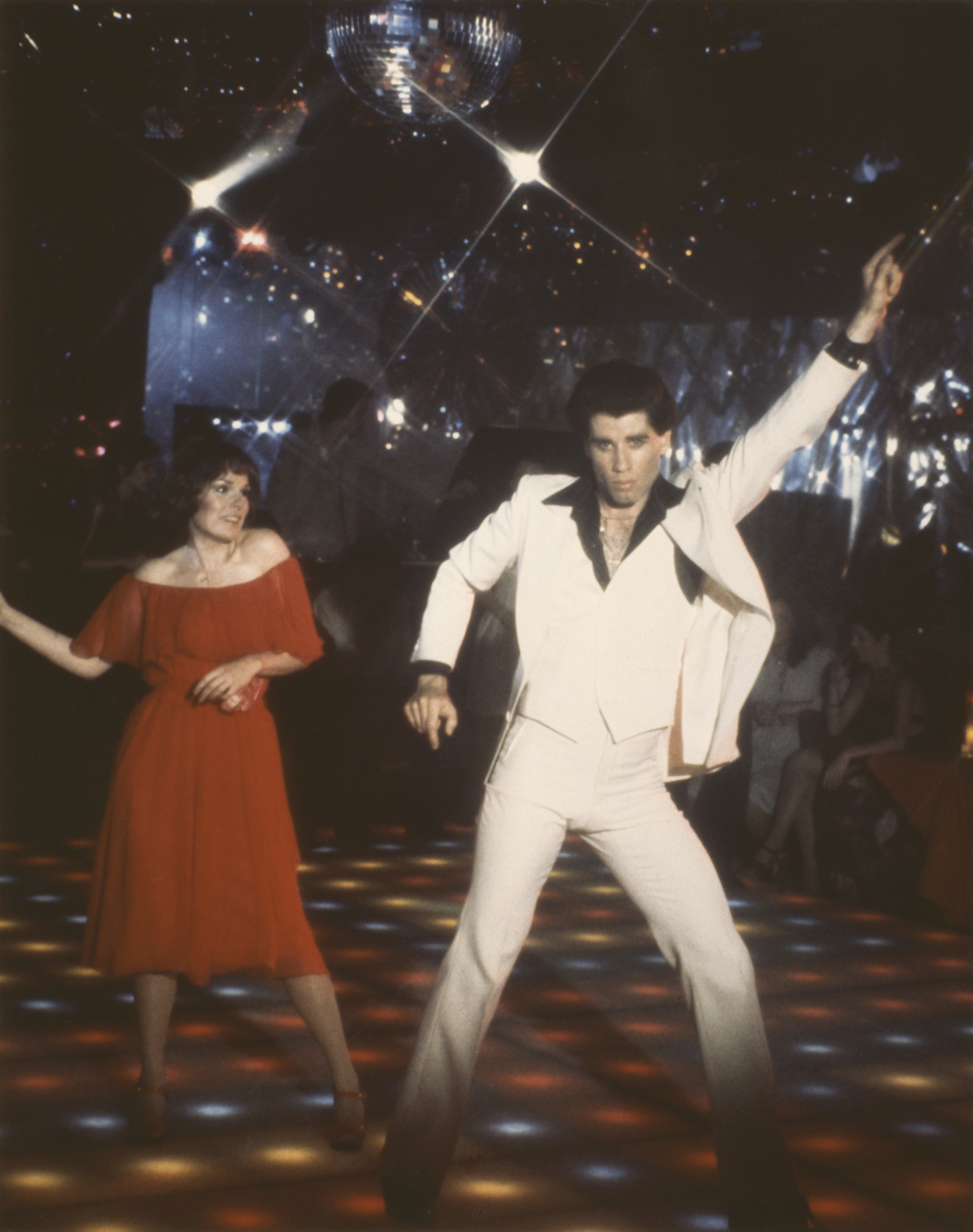 John Travolta and the actress on the set of "Saturday Night Fever" in 1977. | Source: Getty Images