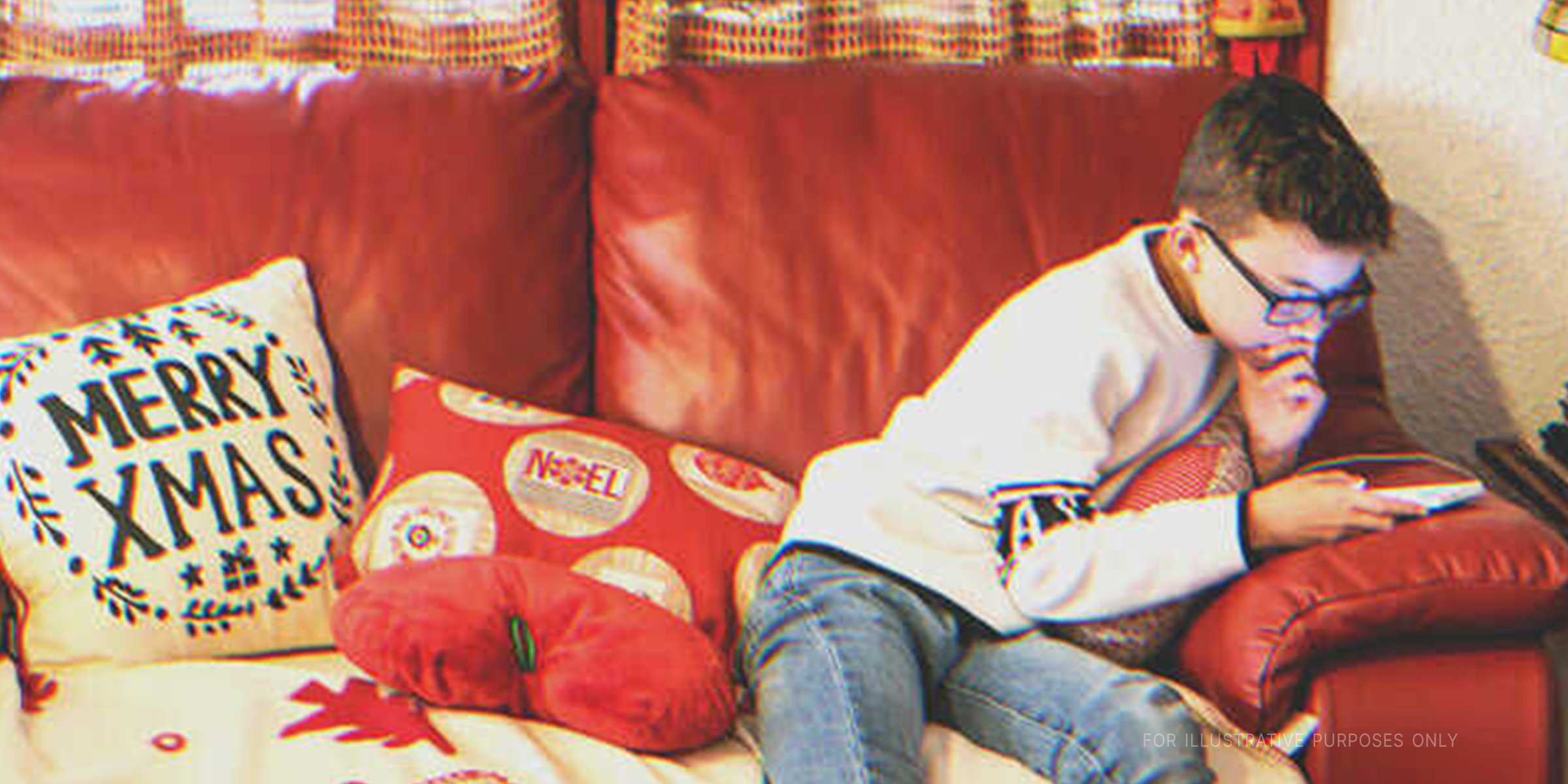 Boy Using His Phone On Couch. | Source: Getty Images