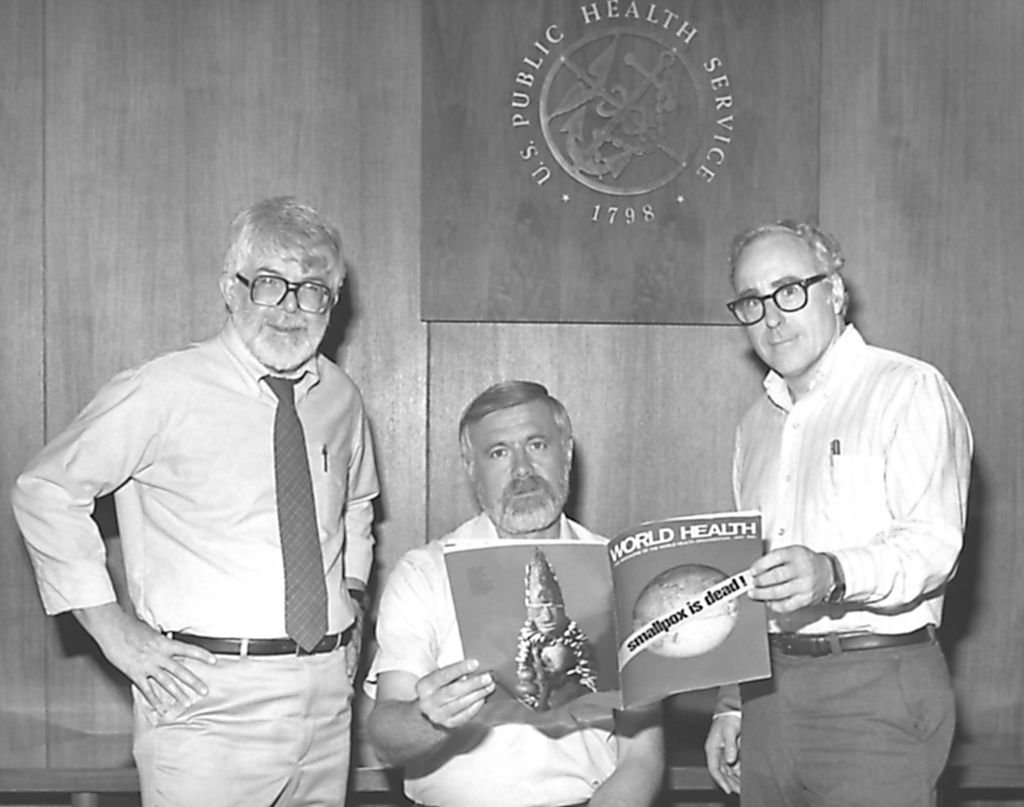 Three former directors of the Global Smallpox Eradication Program, Dr J. Donald Millar, Dr William H. Foege and Dr J. Michael Lane, holding world Health magazine, 1980. Image courtesy Centers for Disease Control (CDC) | Source: Getty Images