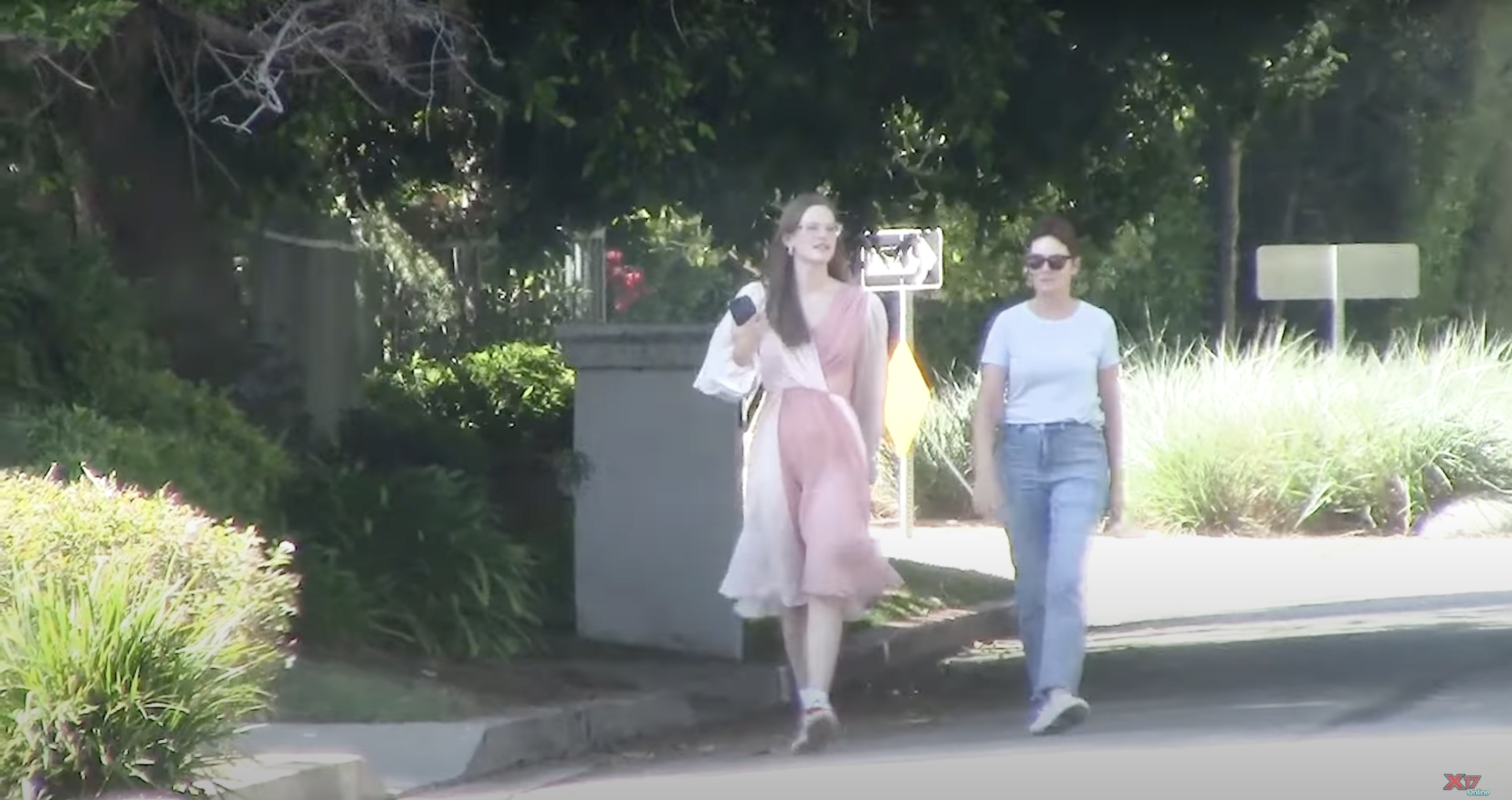 Violet Affleck looks relaxed in Jennifer Lopez's Dolce & Gabbana dress paired with sneakers, posted on August 12, 2024 | Source: YouTube/x17online