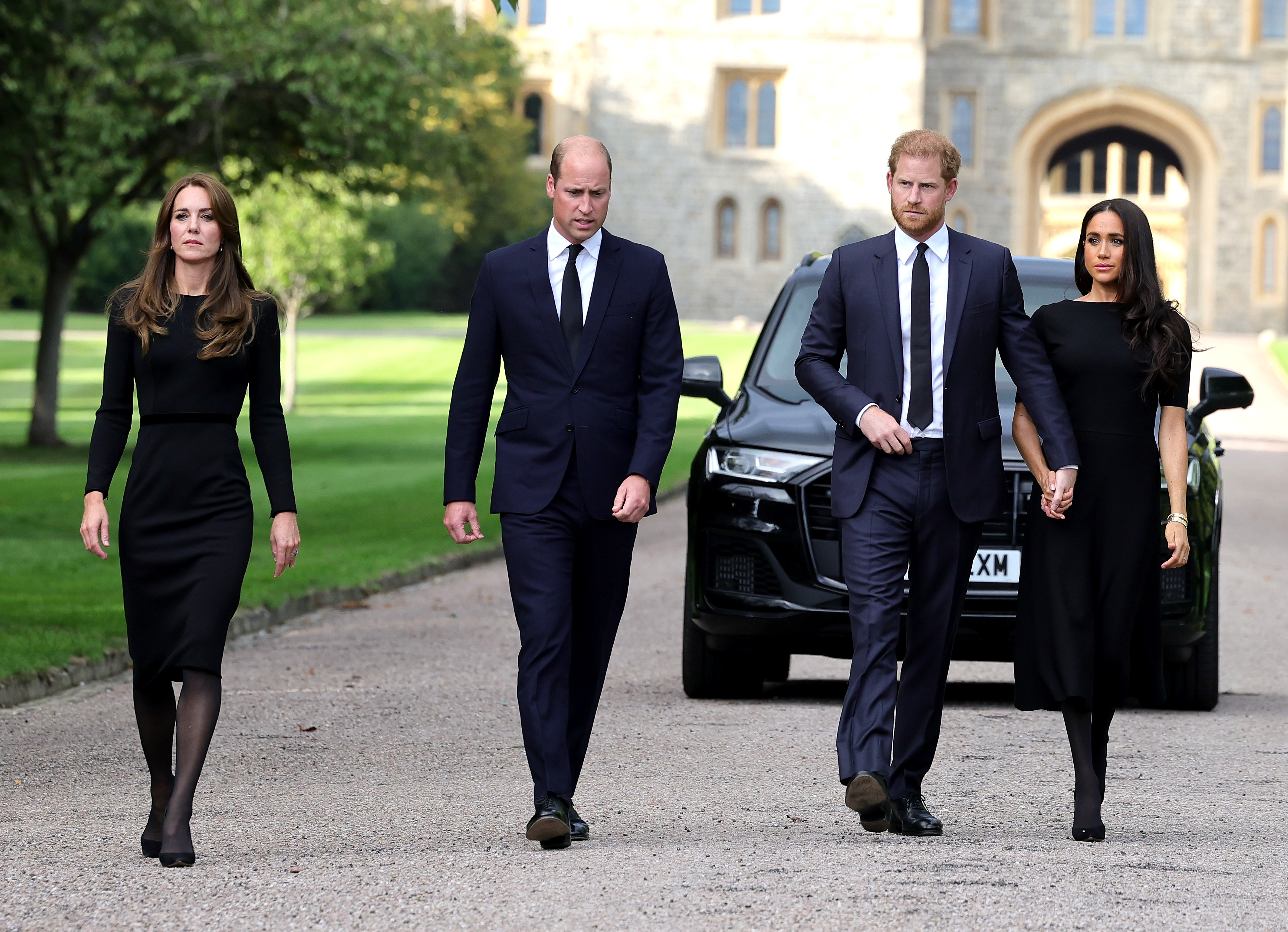 Princess Catherine, Prince William, Prince Harry and Meghan Markle on their way to view flowers and tributes to the late Queen Elizabeth II in Windsor, England on September 10, 2022 | Source: Getty Images