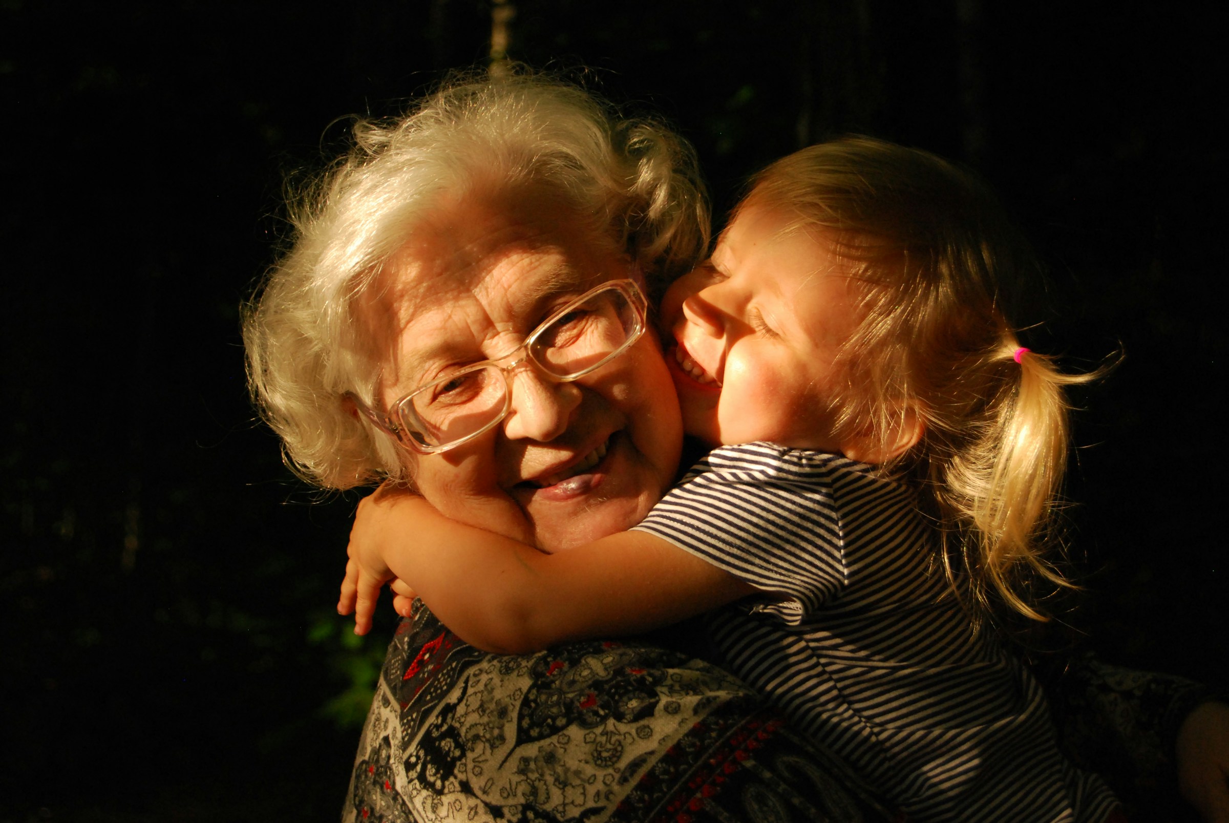 A grandmother hugging her granddaughter | Source: Unsplash