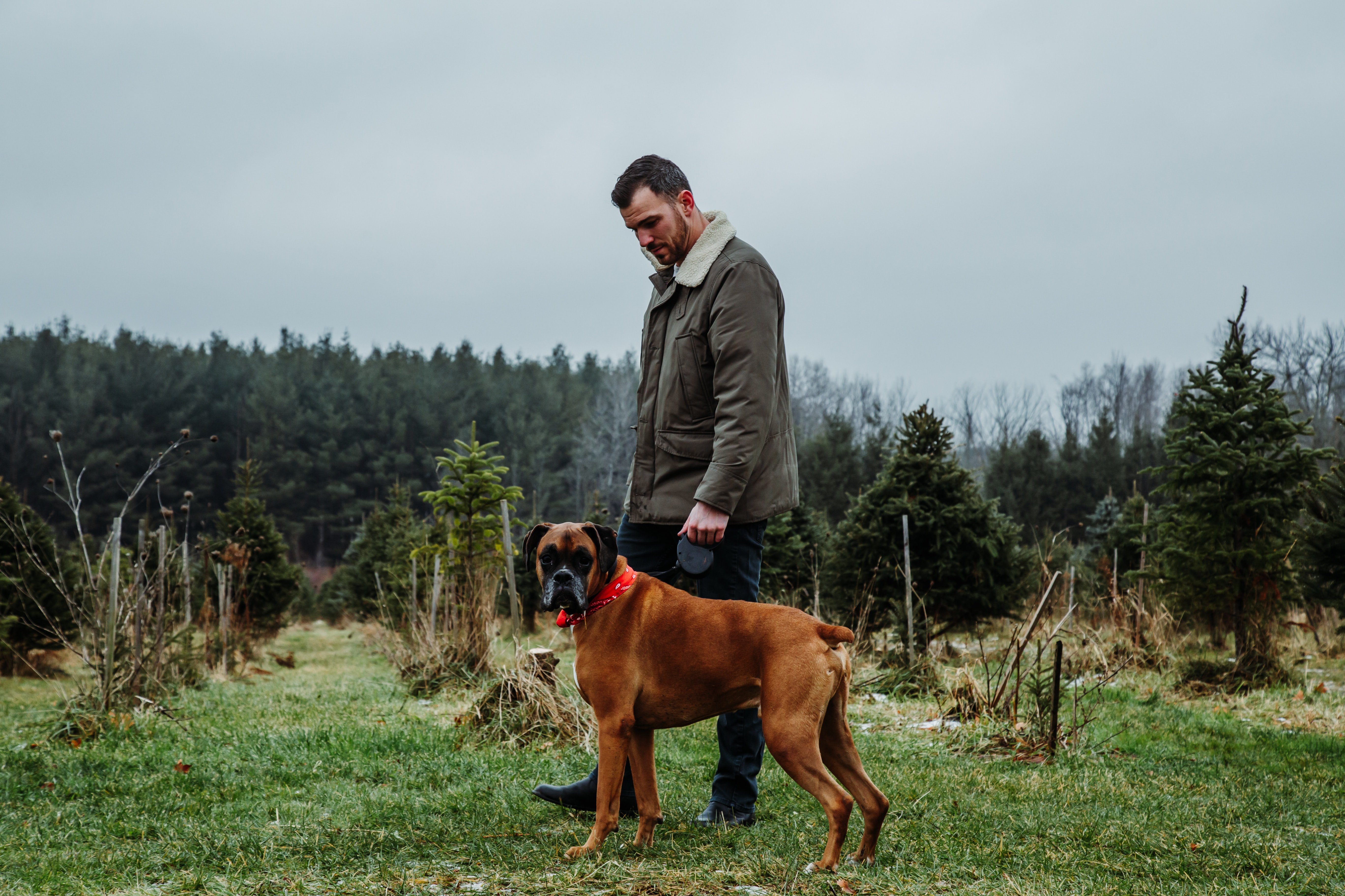 A man standing beside a dog. | Source: Unsplash