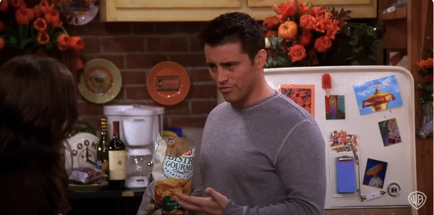 Matt Leblanc as Joey holding a packet of potato chips on the set of "Friends." Source