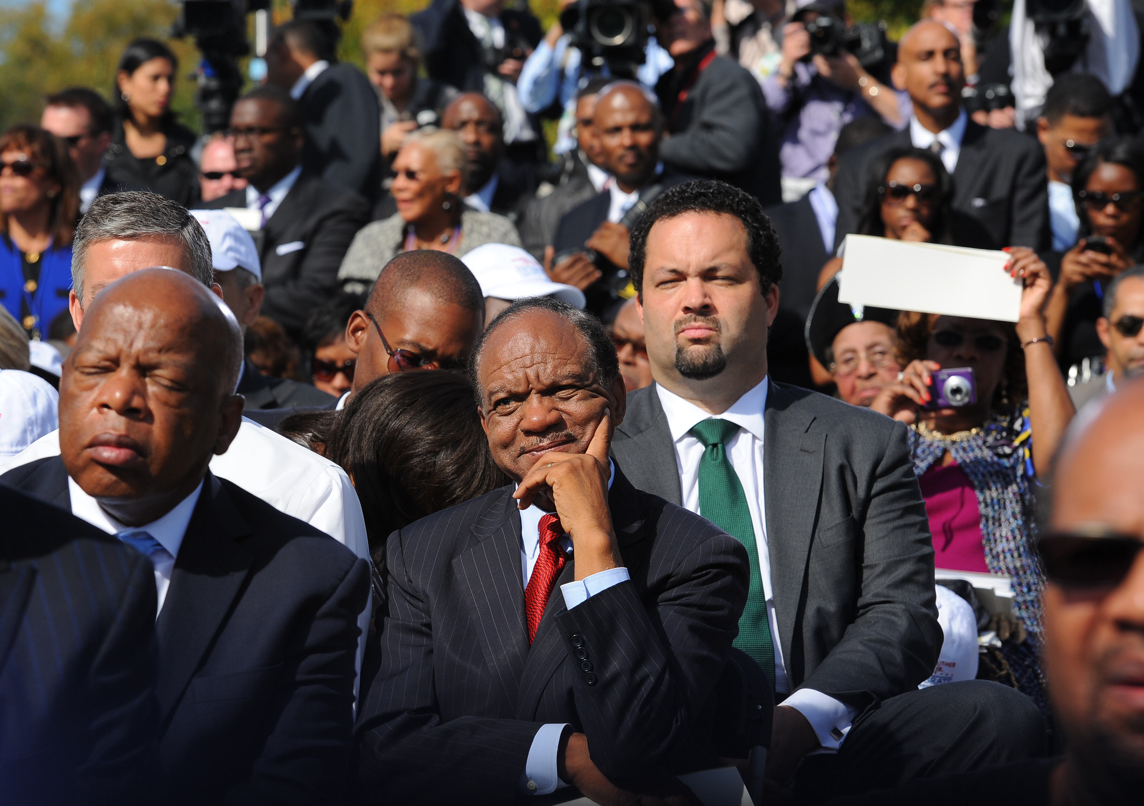 Congressman John Lewis (D-GA), left, and civil rights activist and pastor Walter Fauntroy, center, listen as President Barack Obama speaks during a dedication ceremony at The Martin Luther King, Jr. Memorial on October 16, 2011, in Washington, D.C. | Source: Getty Images