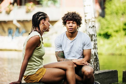 Photo of a couple sitting down by canal together  | Photo: Getty Images