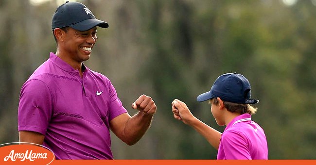  Tiger Woods of the United States and son Charlie Woods high five after a birdie on the ninth hole during the first round of the PNC Championship at the Ritz Carlton Golf Club on December 19, 2020 in Orlando, Florida | Photo: Getty Images