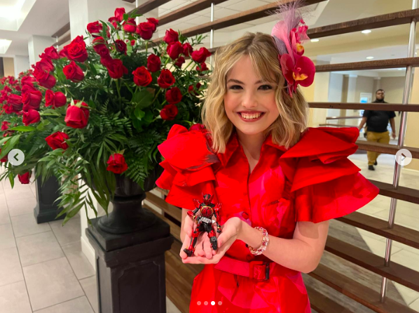 Dannielynn Birkhead posing with an action figure of the character her dress was inspired by, posted on May 4, 2024 | Source: Instagram/larryanddannielynn