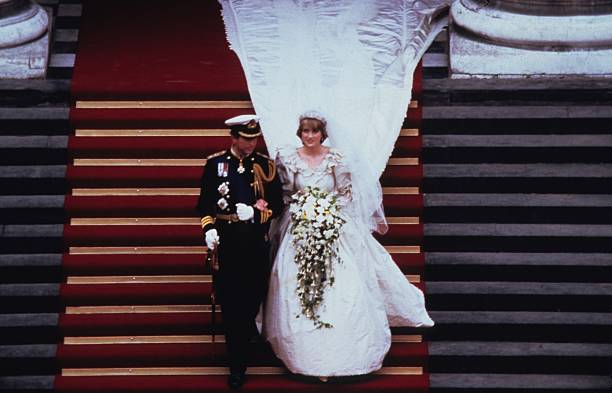 Prince Charles, Prince of Wales and Diana, Princess of Wales, wearing a wedding dress designed by David and Elizabeth Emanuel and the Spencer family Tiara, leave St. Paul's Cathedral following their wedding on July 29, 1981 in London, England | Photo: Anwar Hussein/Getty Images