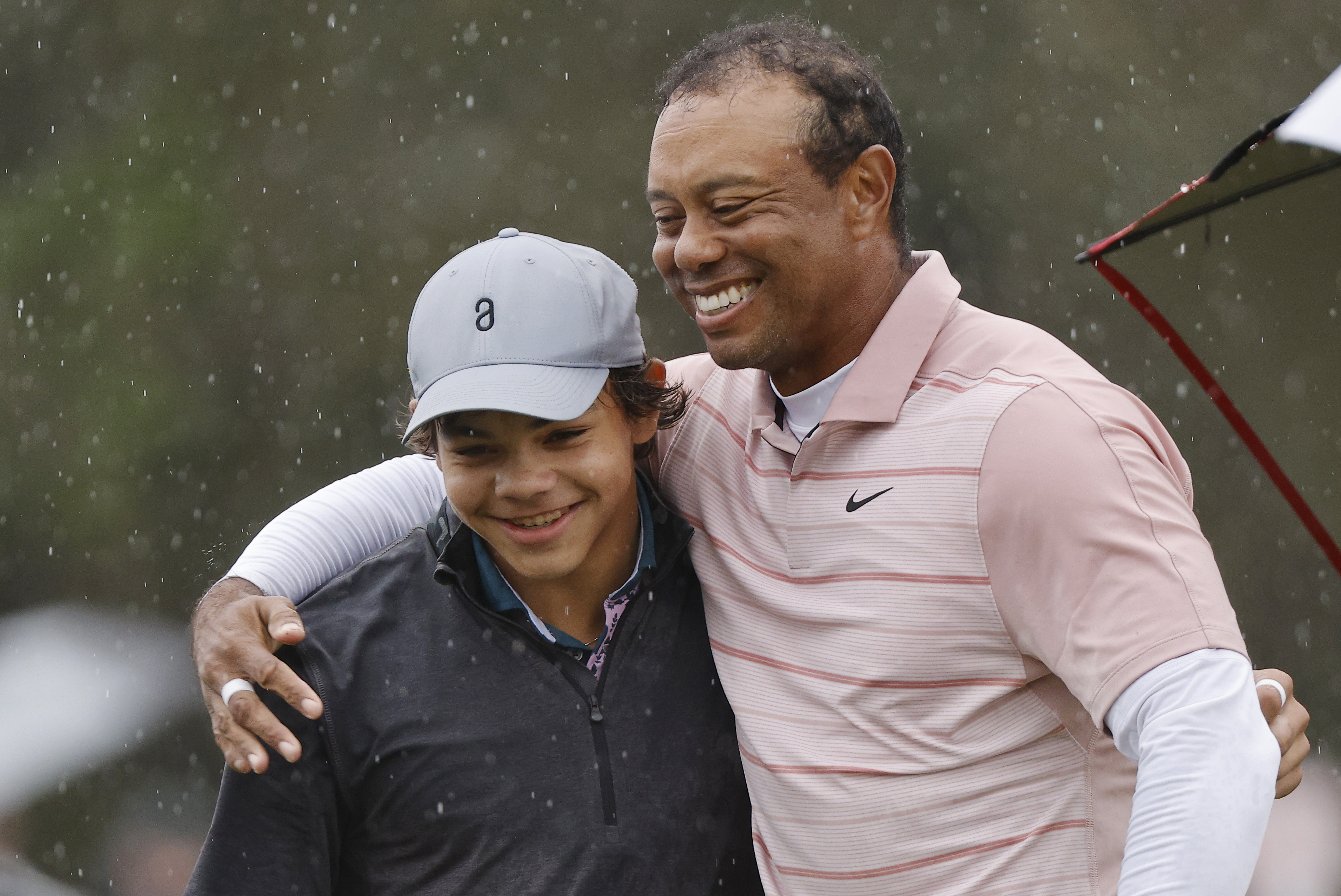 Charlie Woods and Tiger Woods on December 16, 2023, in Orlando, Florida | Source: Getty Images