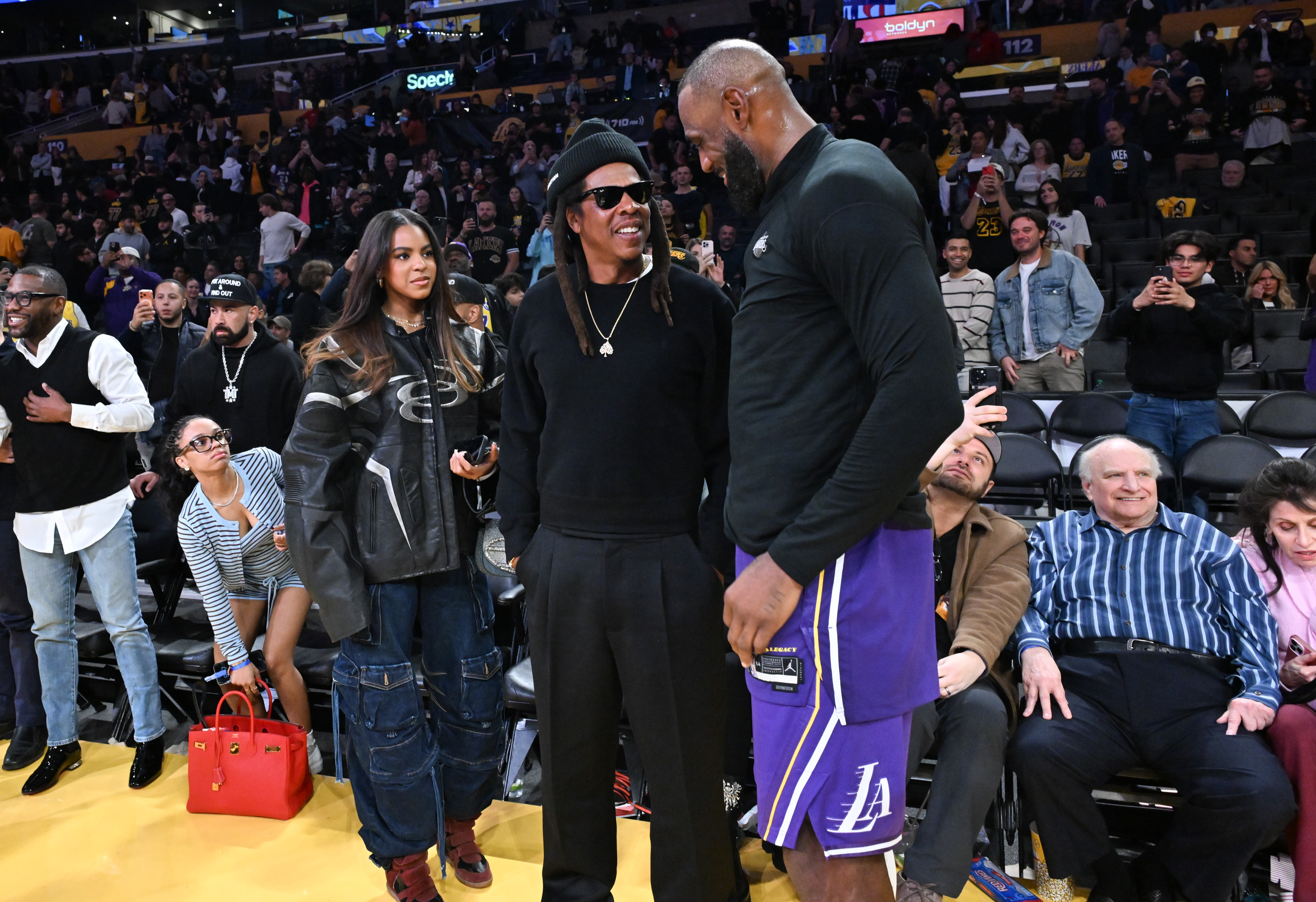 Blue Ivy Carter, Jay-Z, and LeBron James at the game between the Los Angeles Lakers and San Antonio Spurs at Crypto.com Arena in Los Angeles, California, on December 10, 2025 | Source: Getty Images