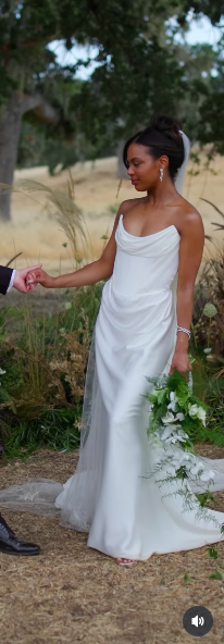 Britt Stewart holding her husband's hand, dressed in her wedding gown. | Source: Instagram/lightcannonfilms