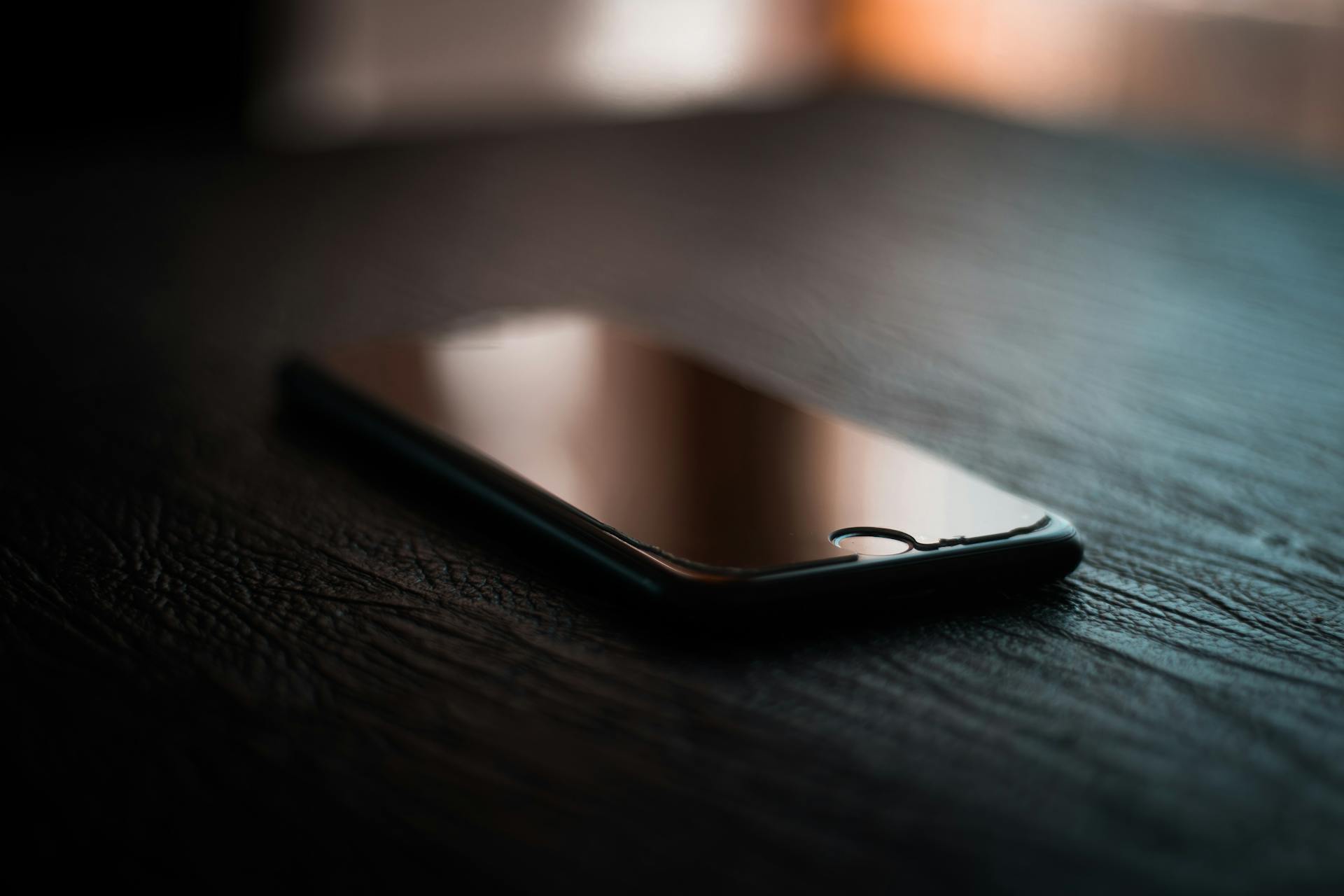 A black phone on a coffee table | Source: Pexels