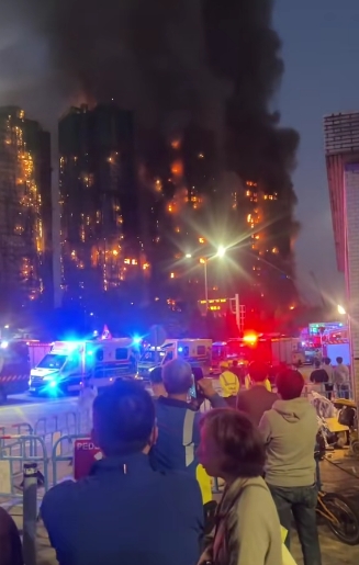 With emergency lights flashing below, flames continue to spread across the facade of the high-rise towers. Witnesses described chaotic scenes as residents fled with pets and valuables, while others remained trapped. At least three men have been arrested as part of a criminal investigation into the blaze. | Source: TikTok/highlight_kutin