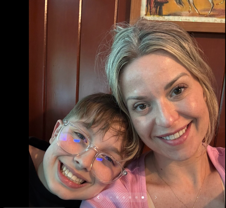 Amanda "Mandy" Karolkiewicz smiles beside one of the couple's sons as they pose for a close-up selfie during the family's spring break vacation. | Source: TikTok/mandykarolk