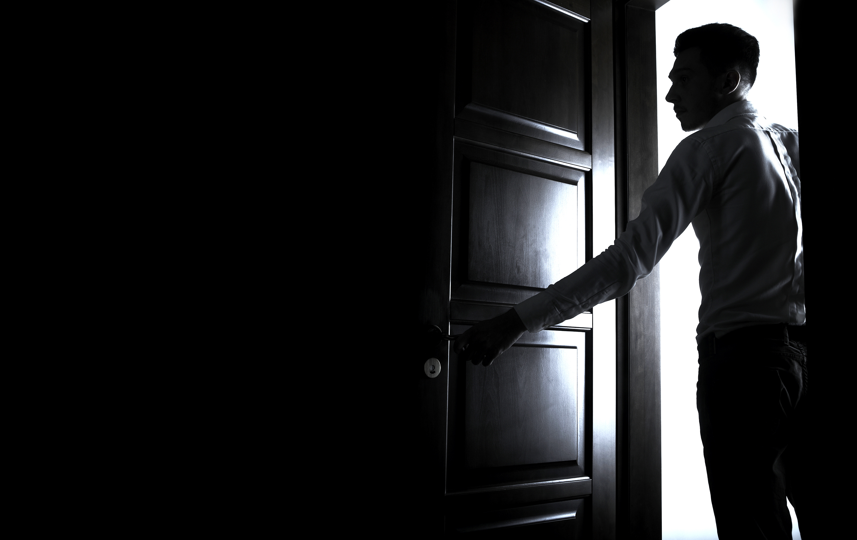 A man opens a door | Source: Shutterstock