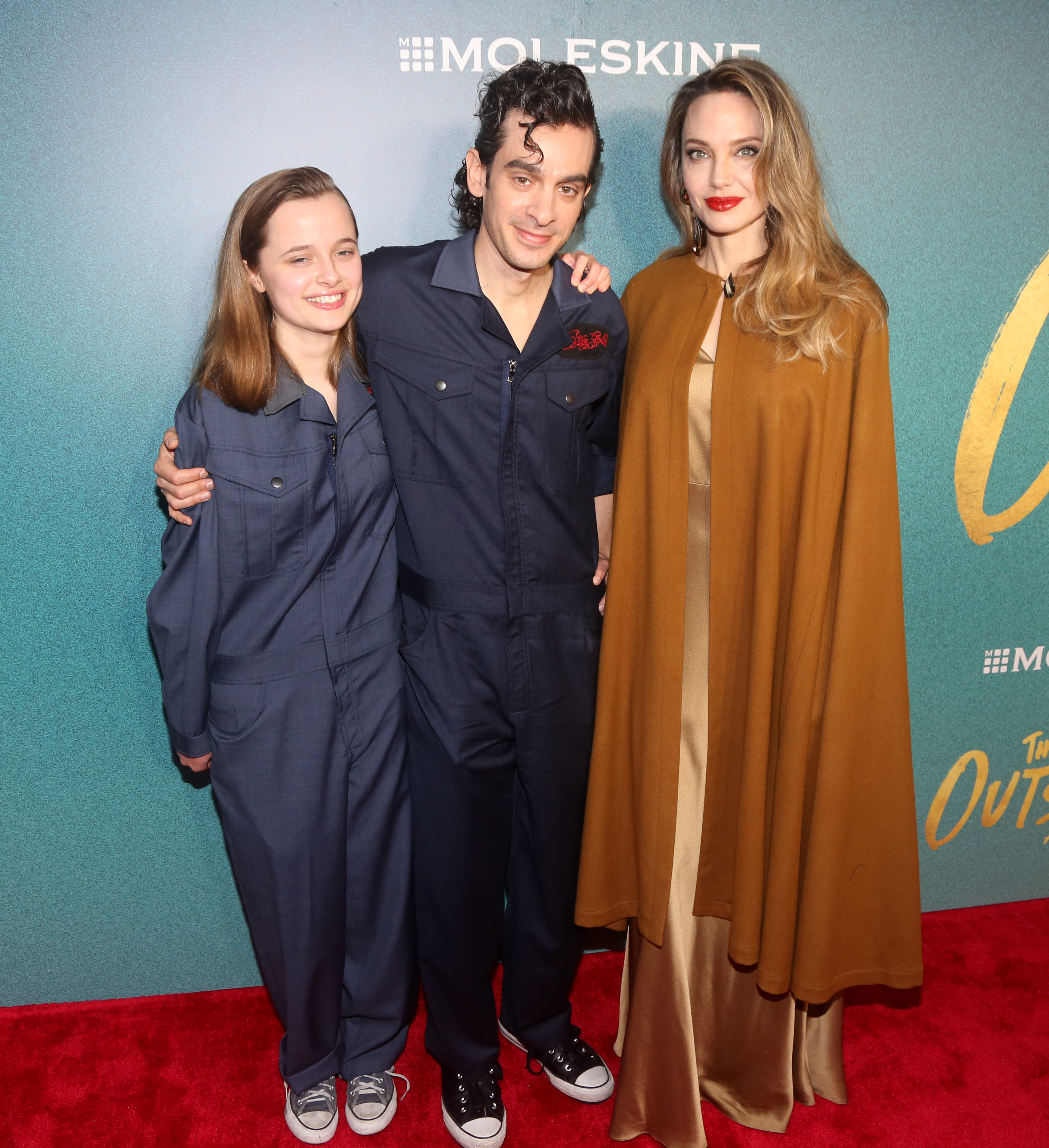Vivienne Jolie-Pitt, Justin Levine, and Angelina Jolie smile on the opening night of "The Outsiders" at The Bernard B. Jacobs Theatre on April 11, 2024, in New York City. | Source: Getty Images