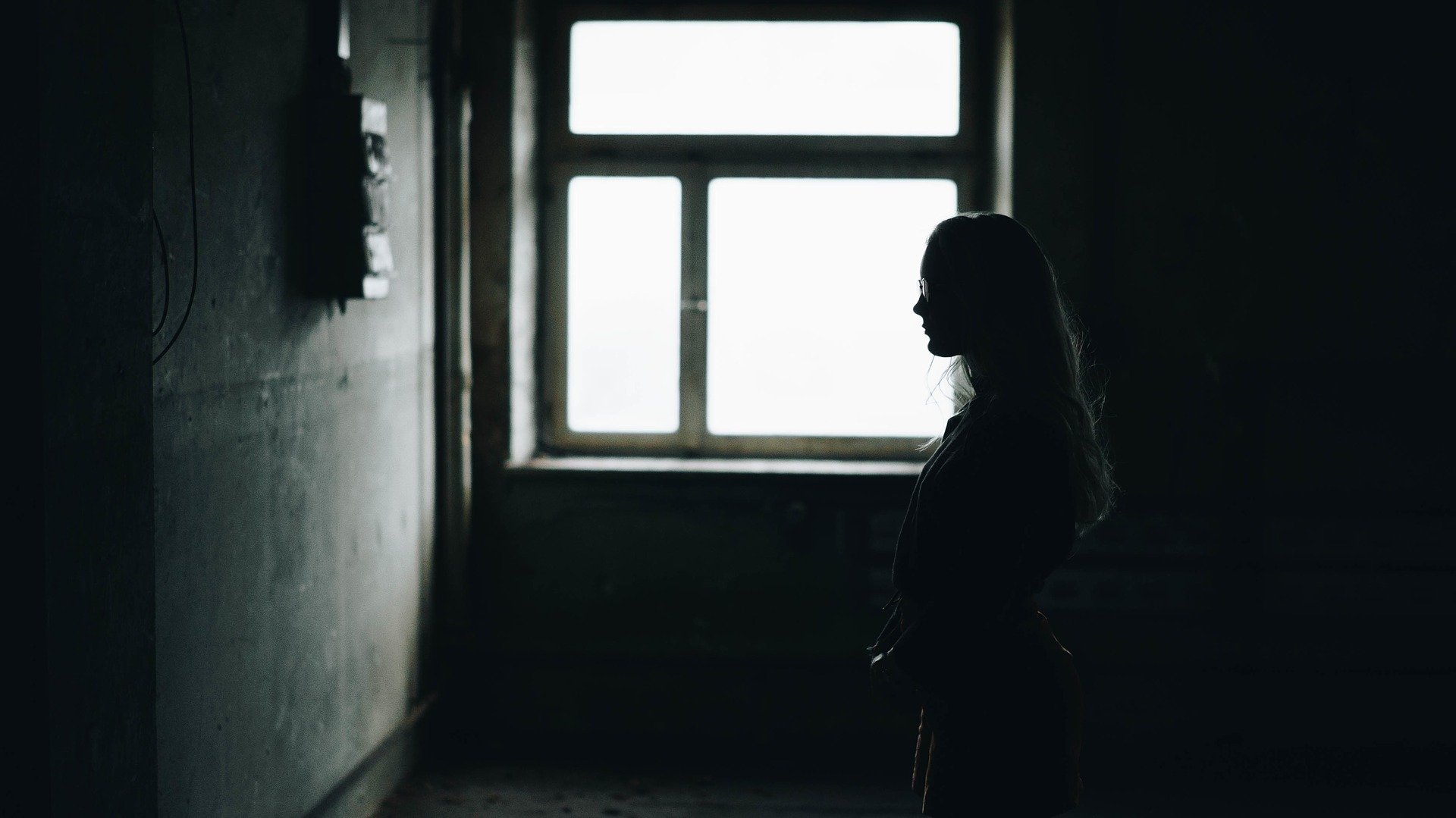 Une femme dans une chambre noire. | Photo : Pixabay