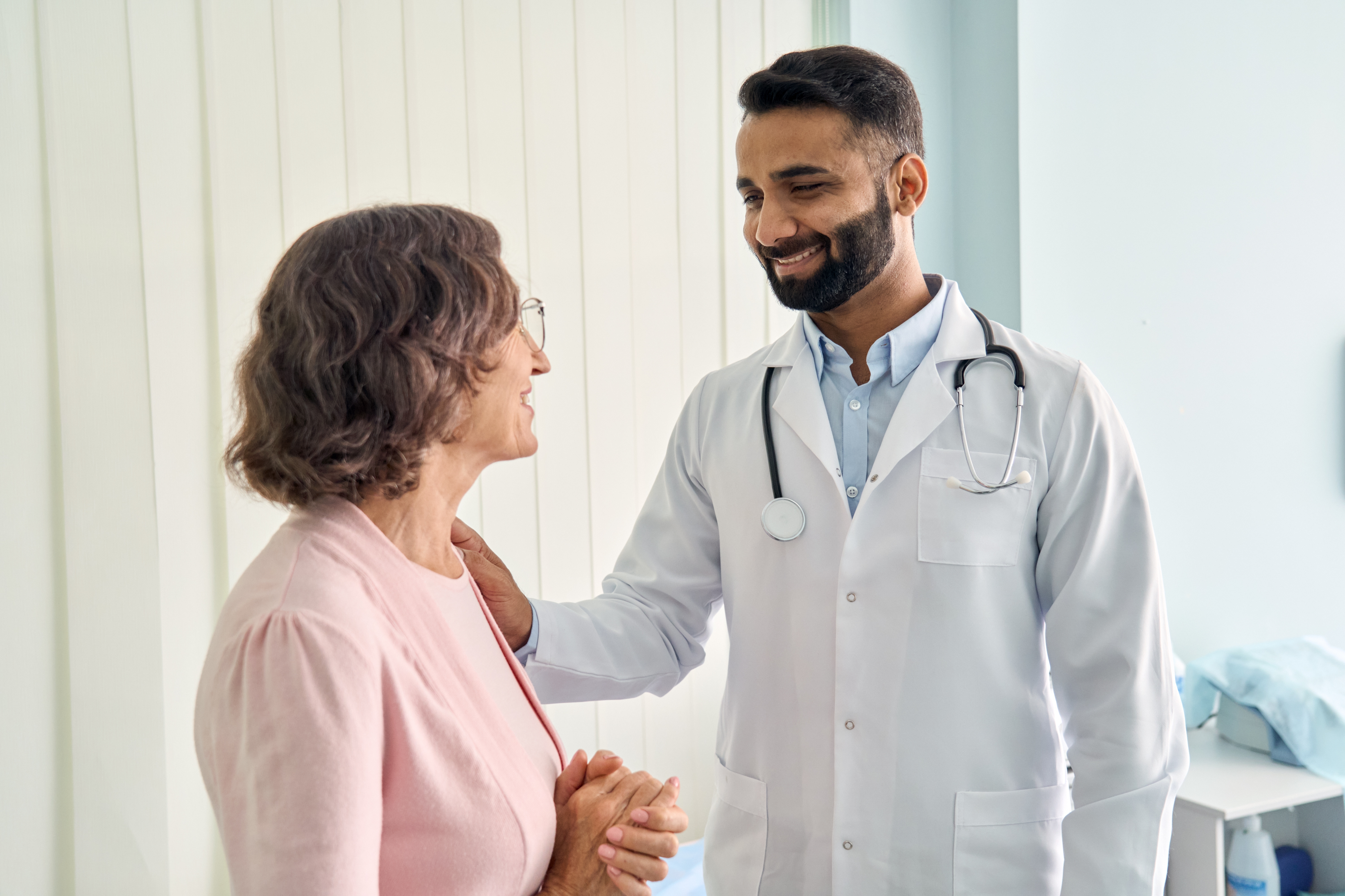 Doctor talks to patient in the hall | Source: Shutterstock