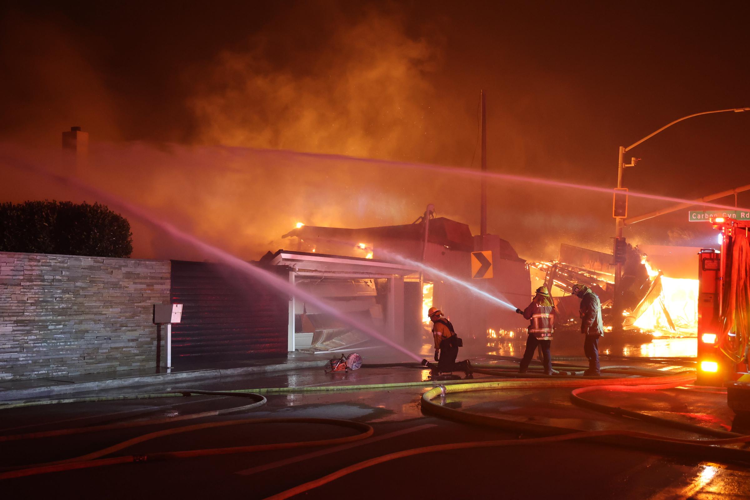 Firefighters battling fire as flames rage across Los Angeles, California, on January 9, 2025 | Source: Getty Images