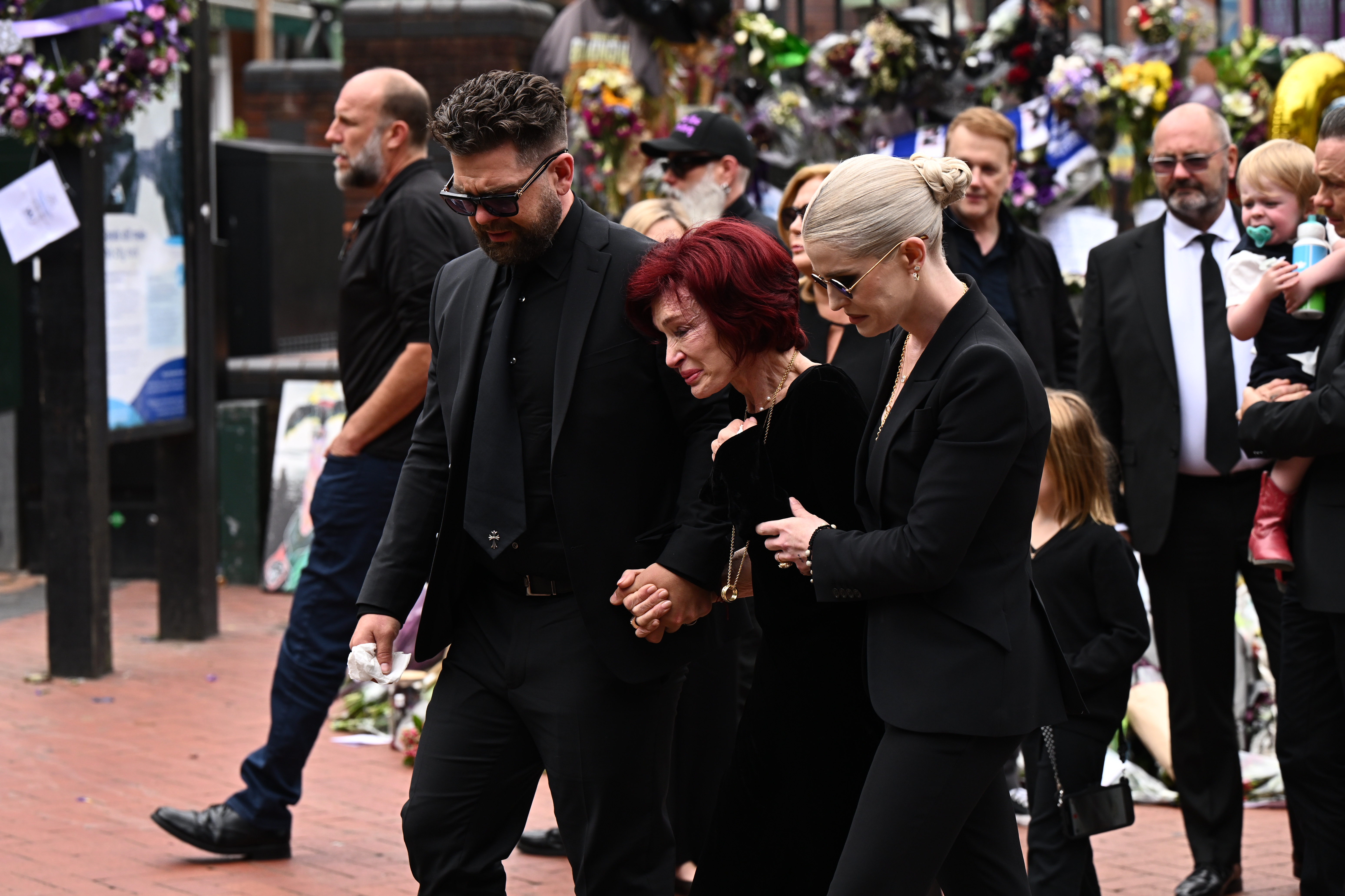 Ozzy's family view tributes from fans to the late Ozzy during his funeral procession in Birmingham on July 30, 2025 | Source: Getty Images