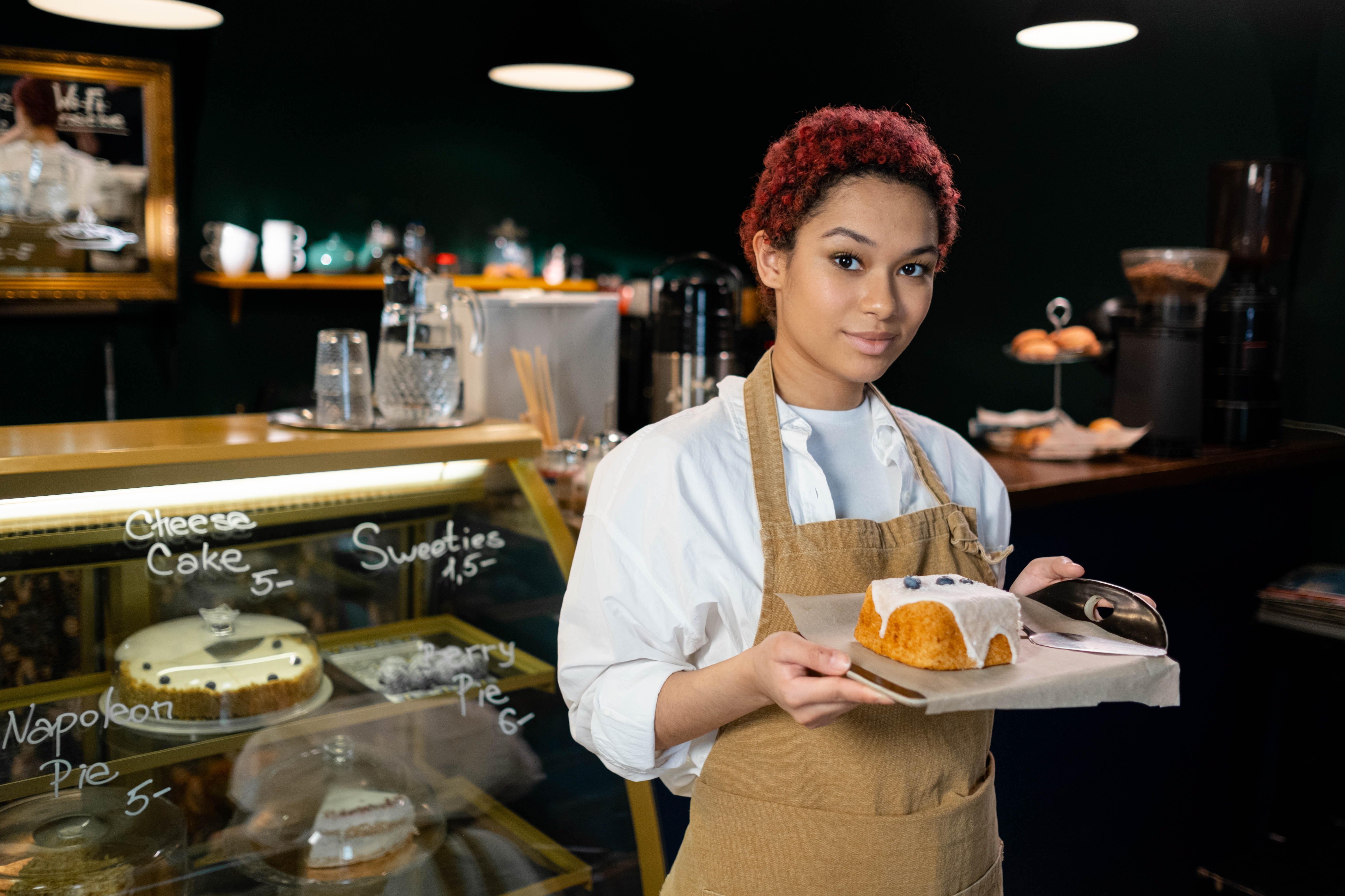 Waitress standing with a cake | Photo: Pexels