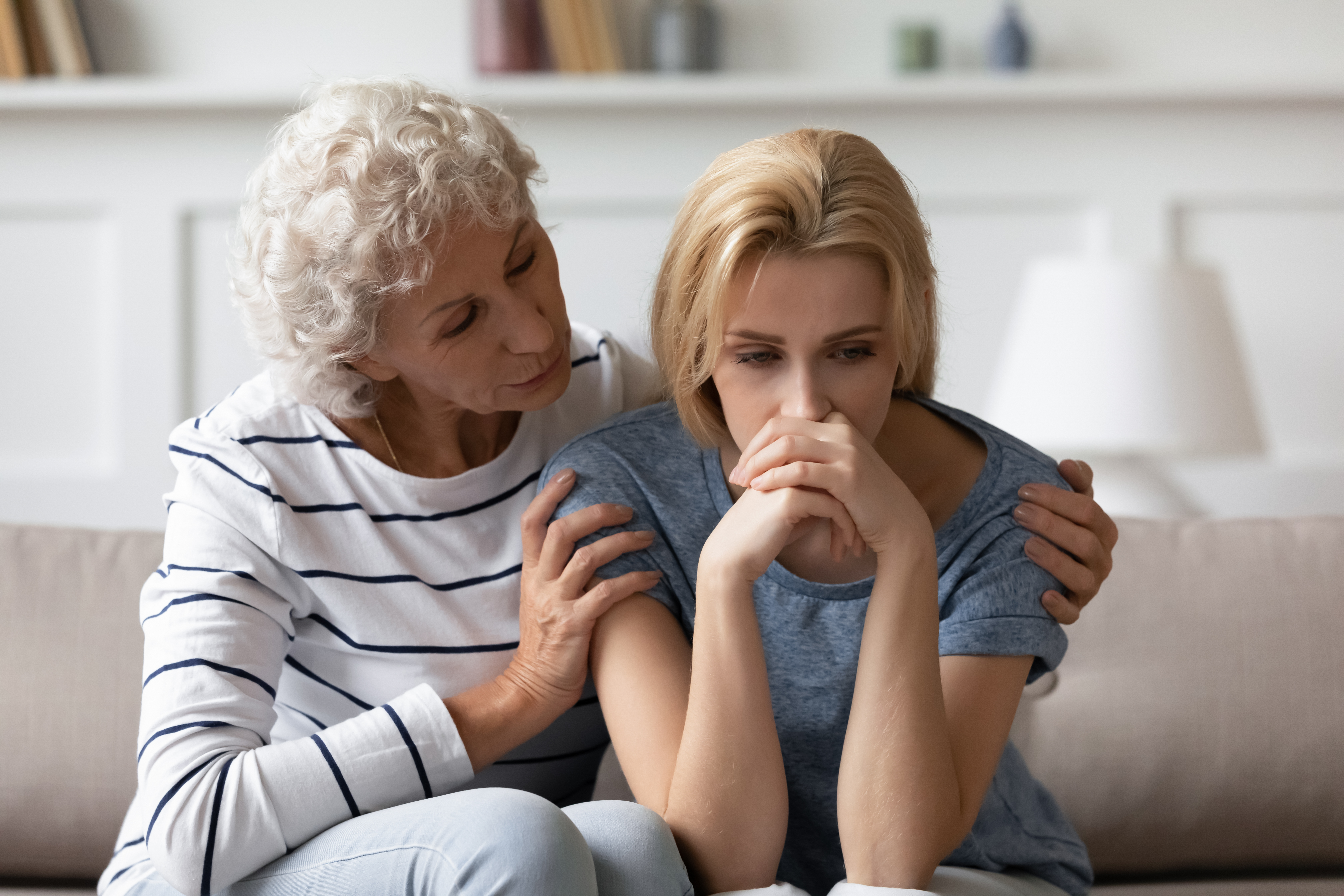 A grandmother comforting a younger woman | Source: Shutterstock