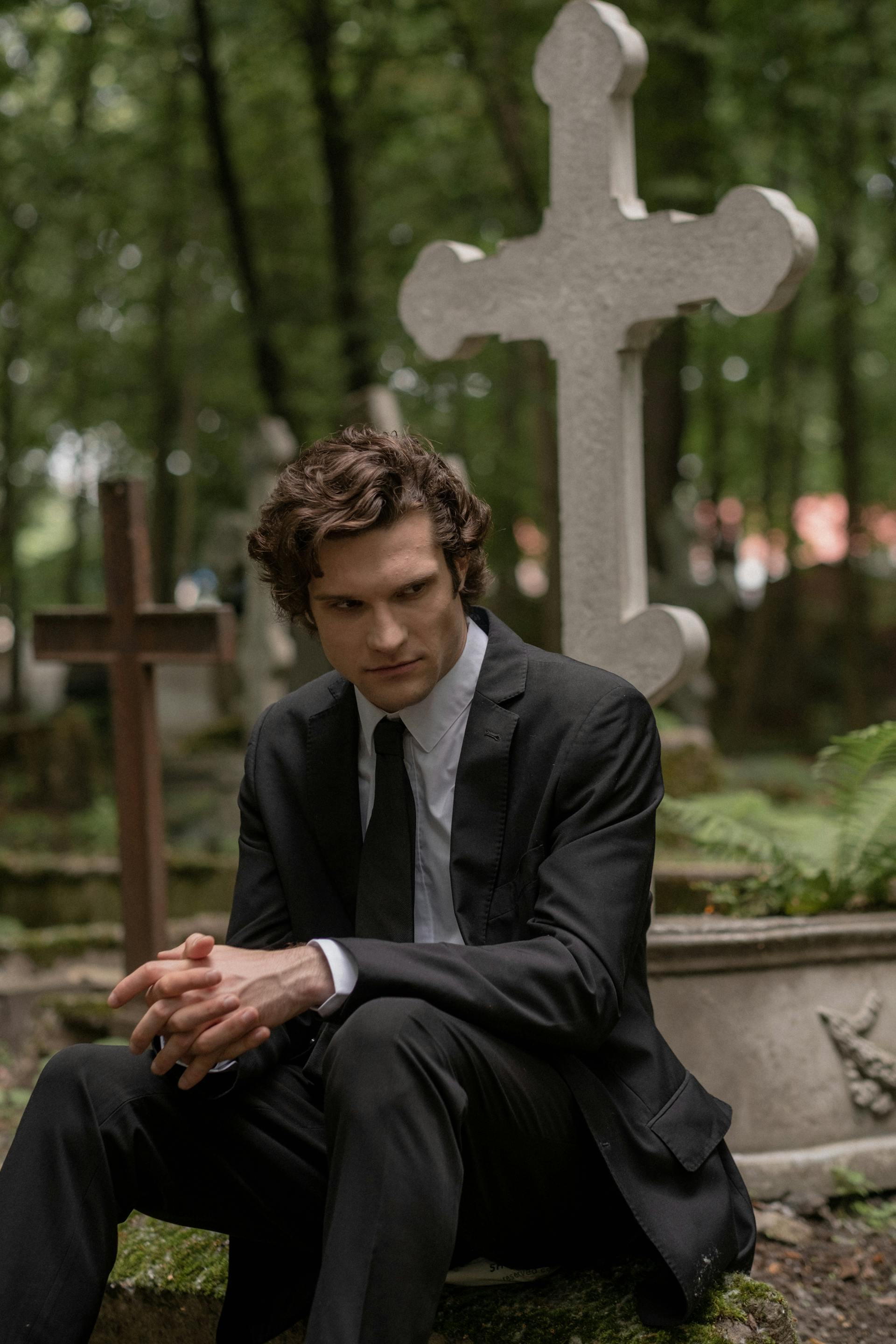 A grieving man in a cemetery | Source: Pexels