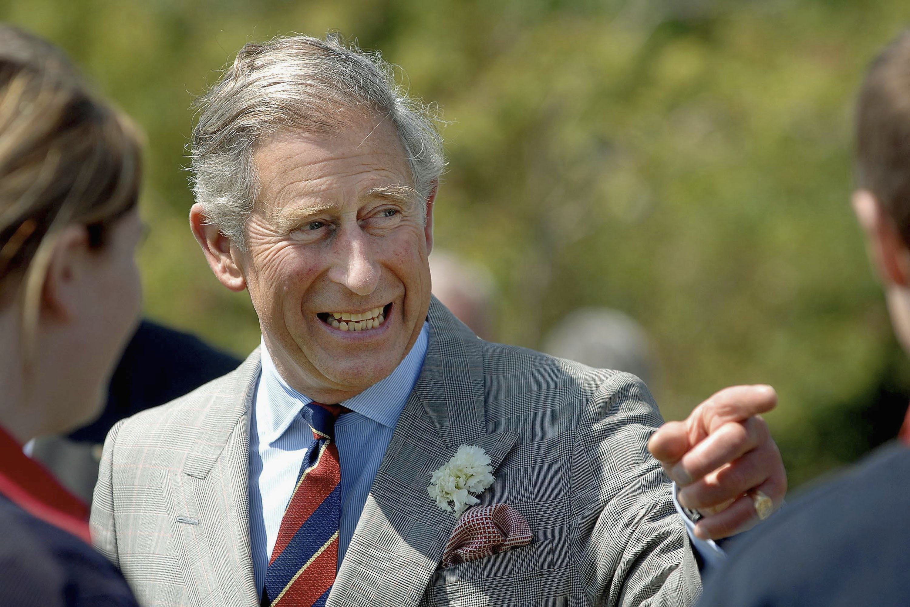 Prince Charles, Prince of Wales jokes with pupils from Ysgol Bodedern during a visit to Llynnon Mill, Llanddeusant on June 7, 2007 in Anglessey, Wales.  | Photo: GettyImages