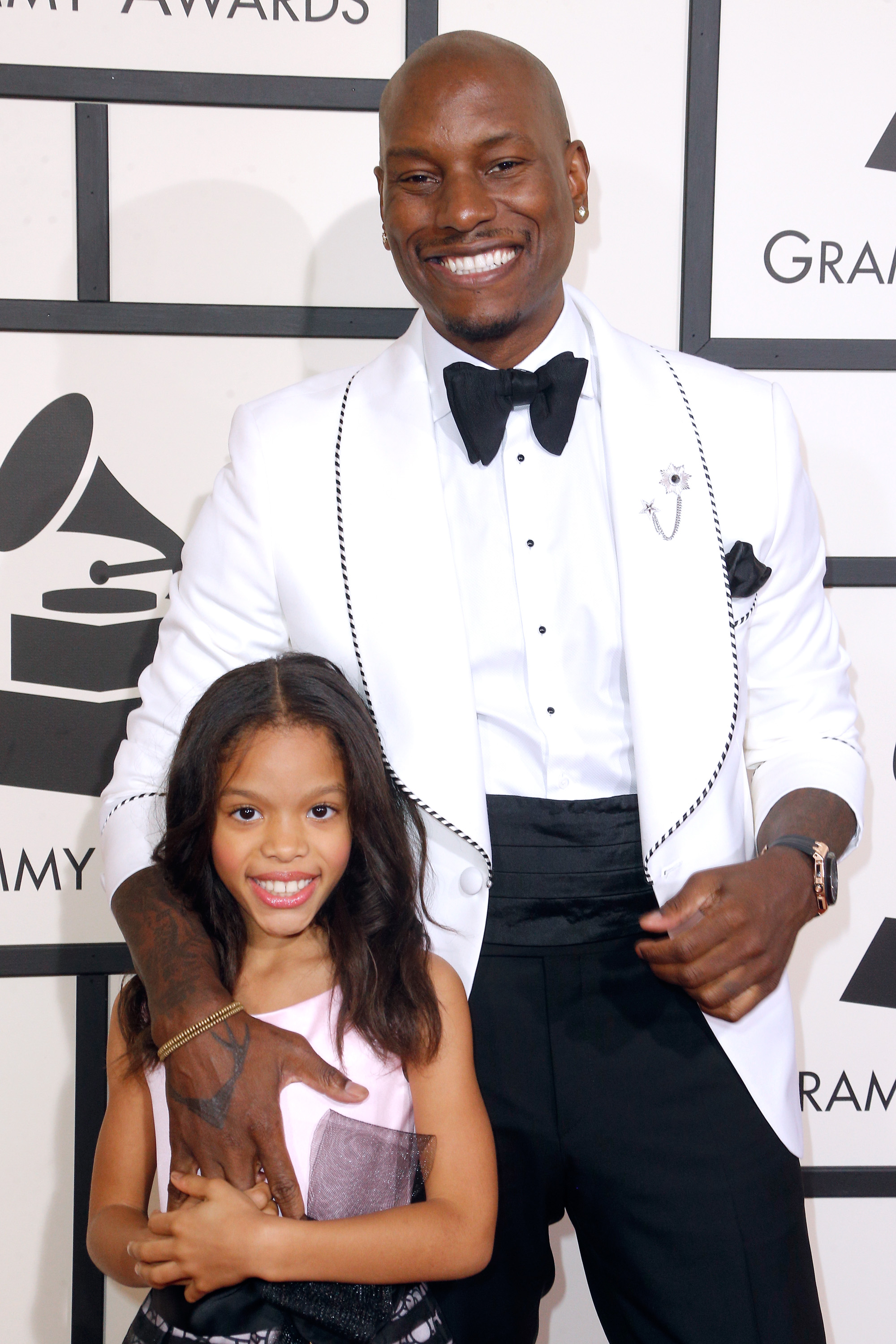 Shayla Gibson looked all grown up standing beside Tyrese Gibson on music’s biggest night, dressed elegantly for the glamorous awards show. Meanwhile, the singer kept things classic in a sharp white tuxedo jacket accented with black trim and a bow tie.